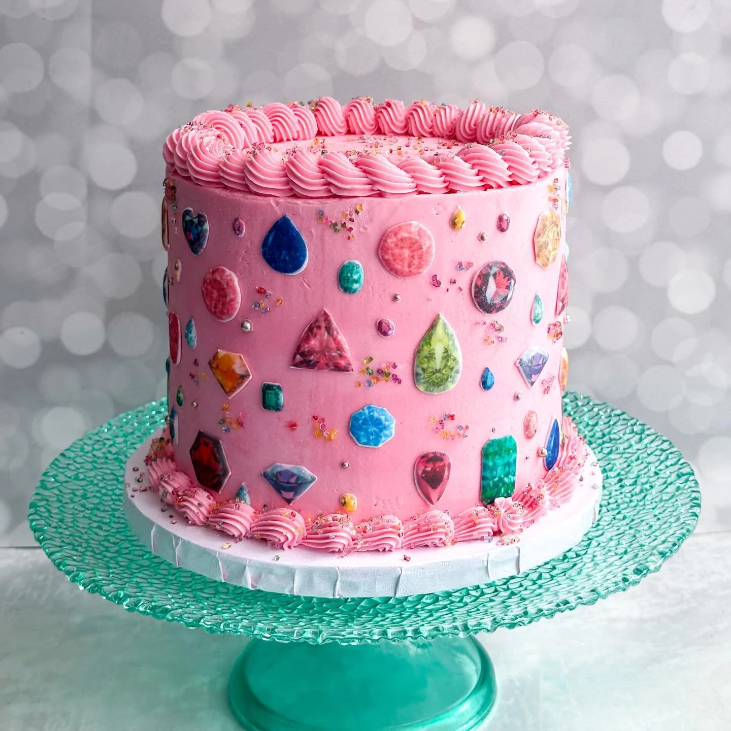 &bull; b e j e w e l e d &bull;

Such a fun cake for a dazzling, gem-inspired birthday party.

Red velvet cake with cream cheese buttercream inside. Wrapped in pink vanilla buttercream and finished with handmade icing jewels and rainbow sugar.

#comf