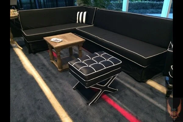 Black L-Shaped Couch with White Piping