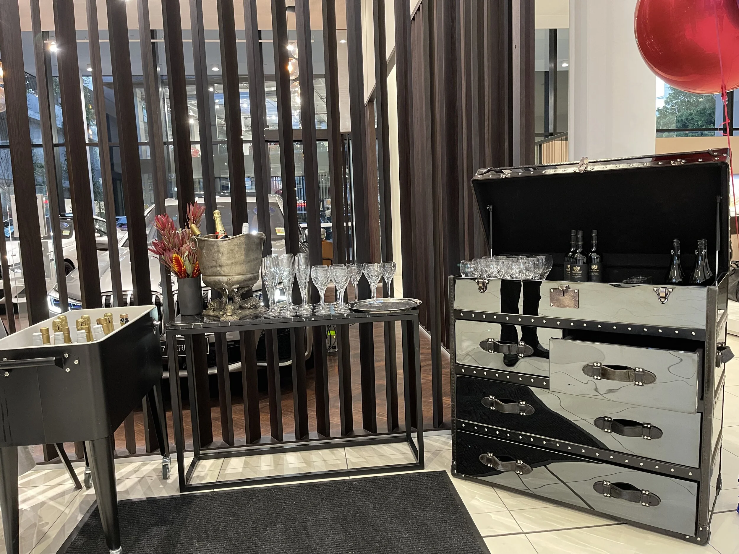 Black Coco bar trunk with marble top side table.jpeg