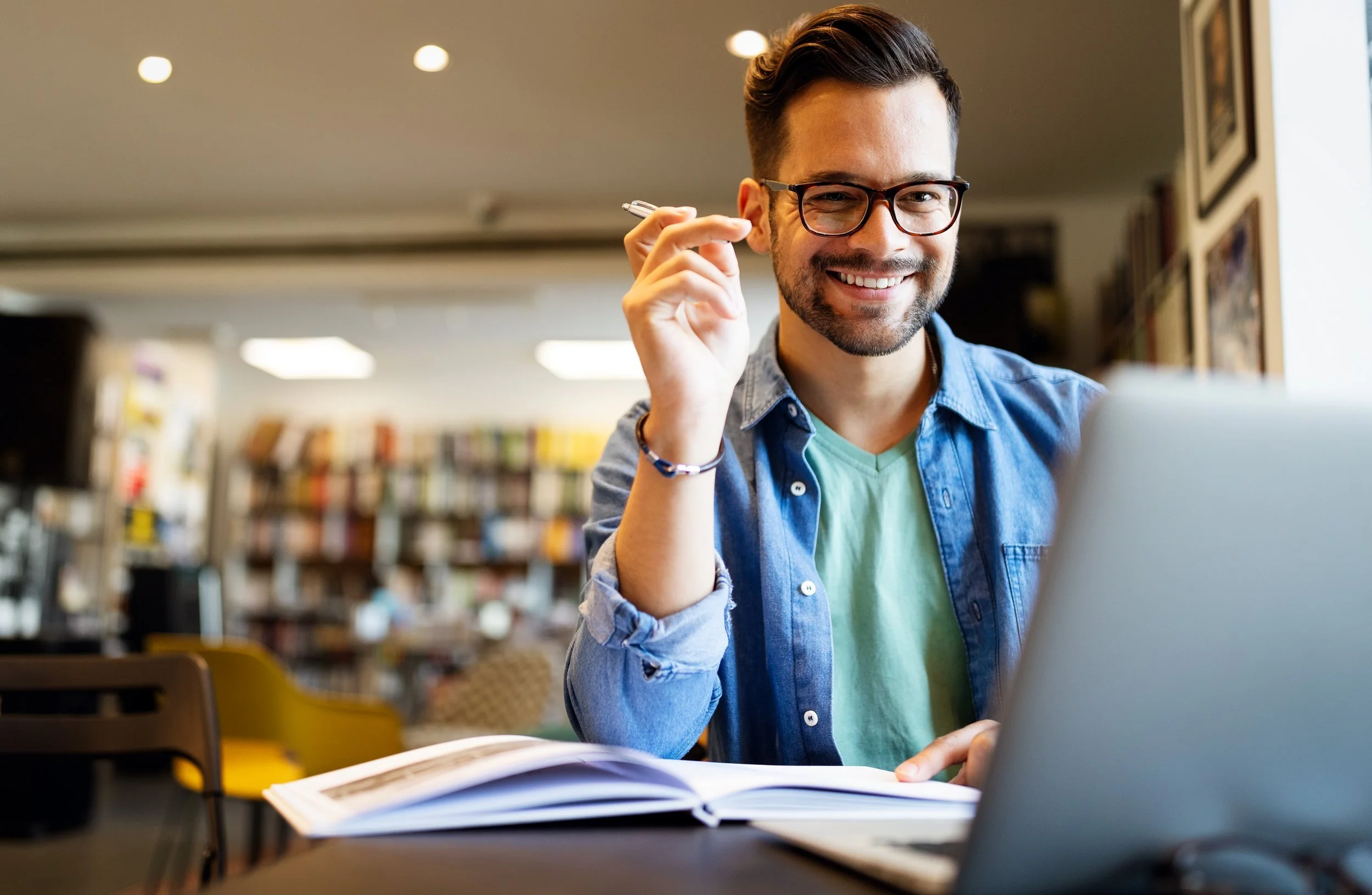 smiling-male-student-working-studying-library.jpg