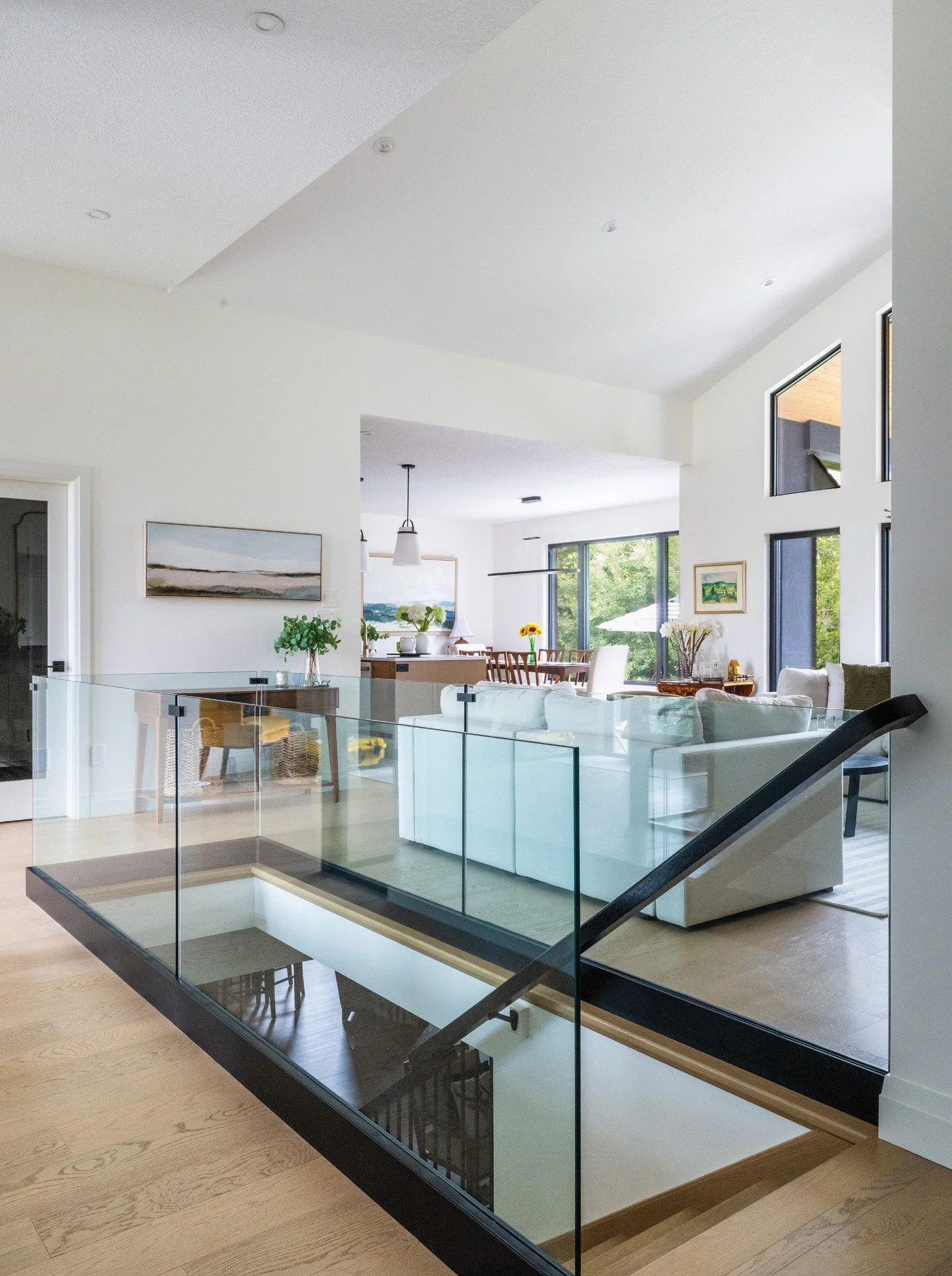 The finished result of this custom home in Kincardine is a bright, open-concept main floor anchored by 11-foot ceilings and expansive glazing. Even functional elements were carefully considered to preserve light flow. The white oak staircase to the l