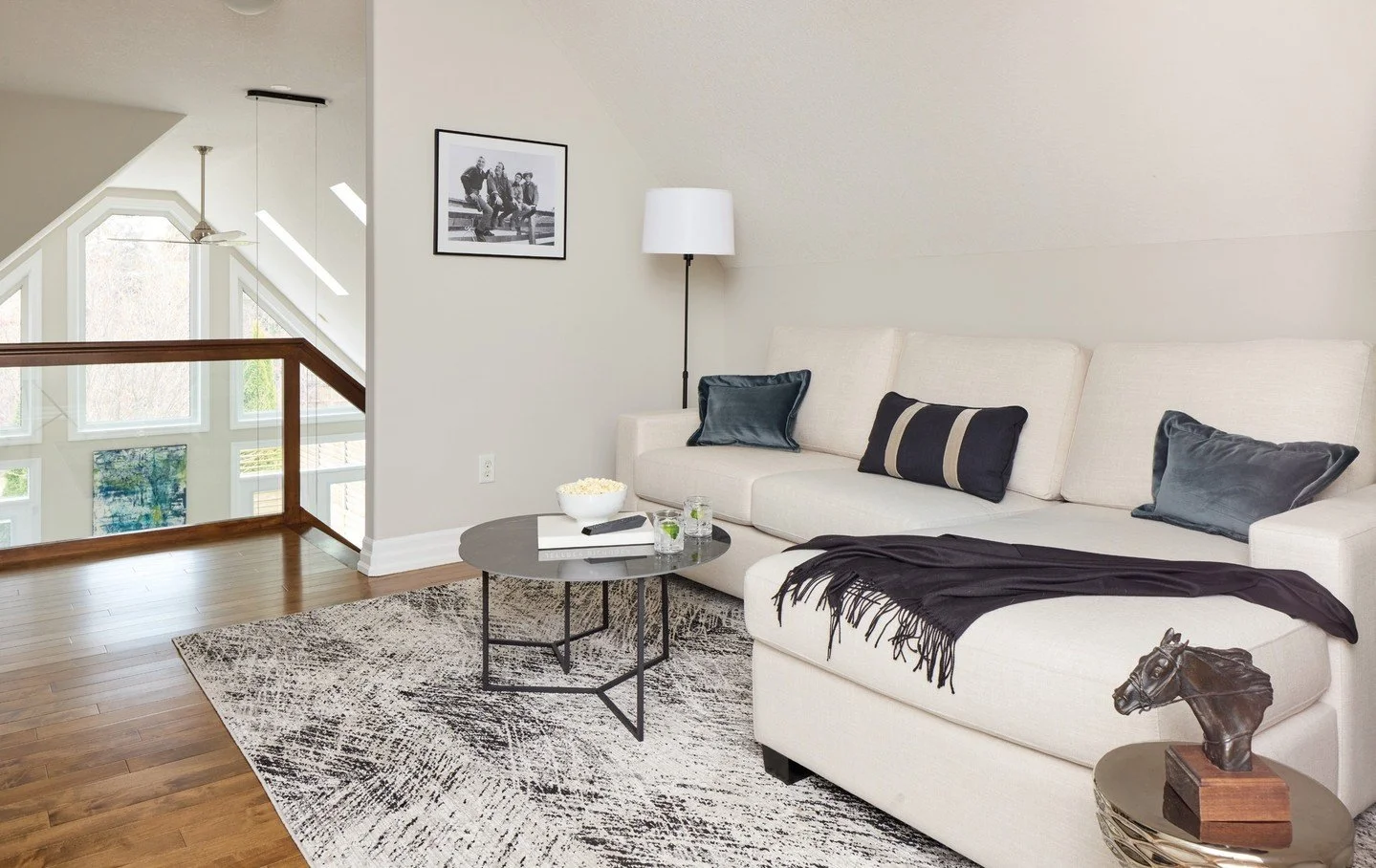 One of the unique features of this lovely home is the secondary living area that overlooks the great room. The main living space viewed from the loft, reveals thoughtful spatial planning with dedicated conversation and dining zones. See this home in 