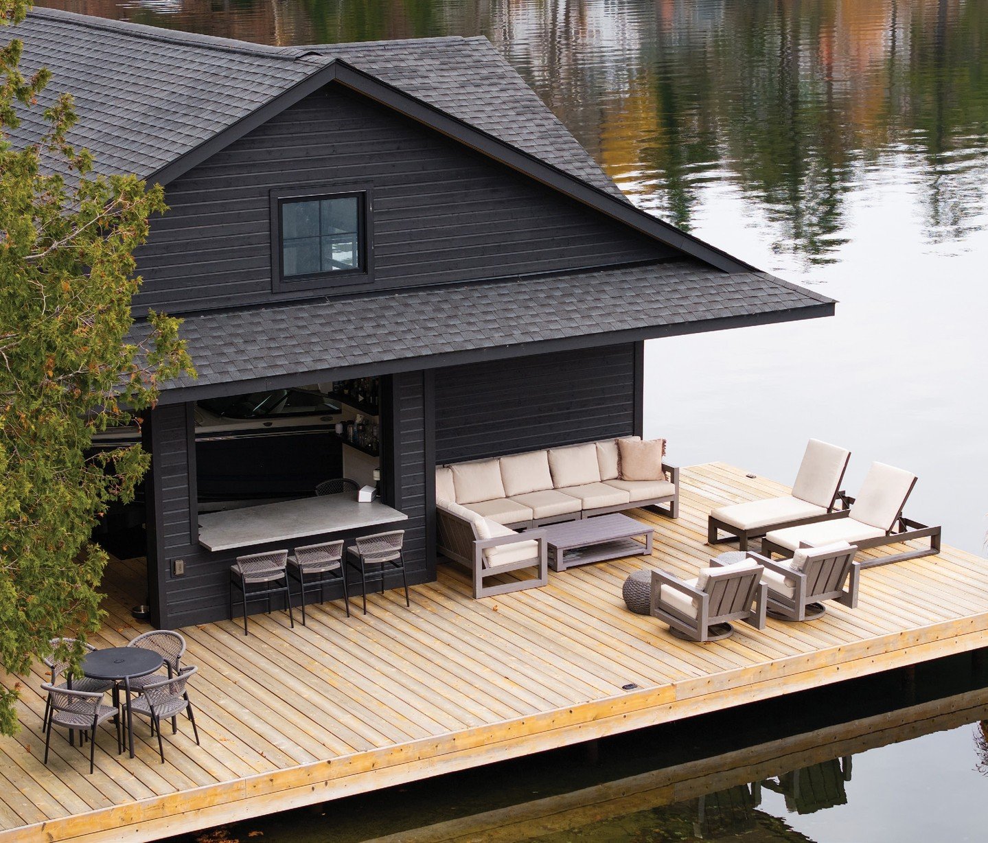 This lovely property on Lake Joseph is set along a tranquil shoreline and tucked into the trees for optimal privacy. Black siding with Douglas fir accents creates a low-key appearance that blends into the terrain. Additionally, the boathouse was desi
