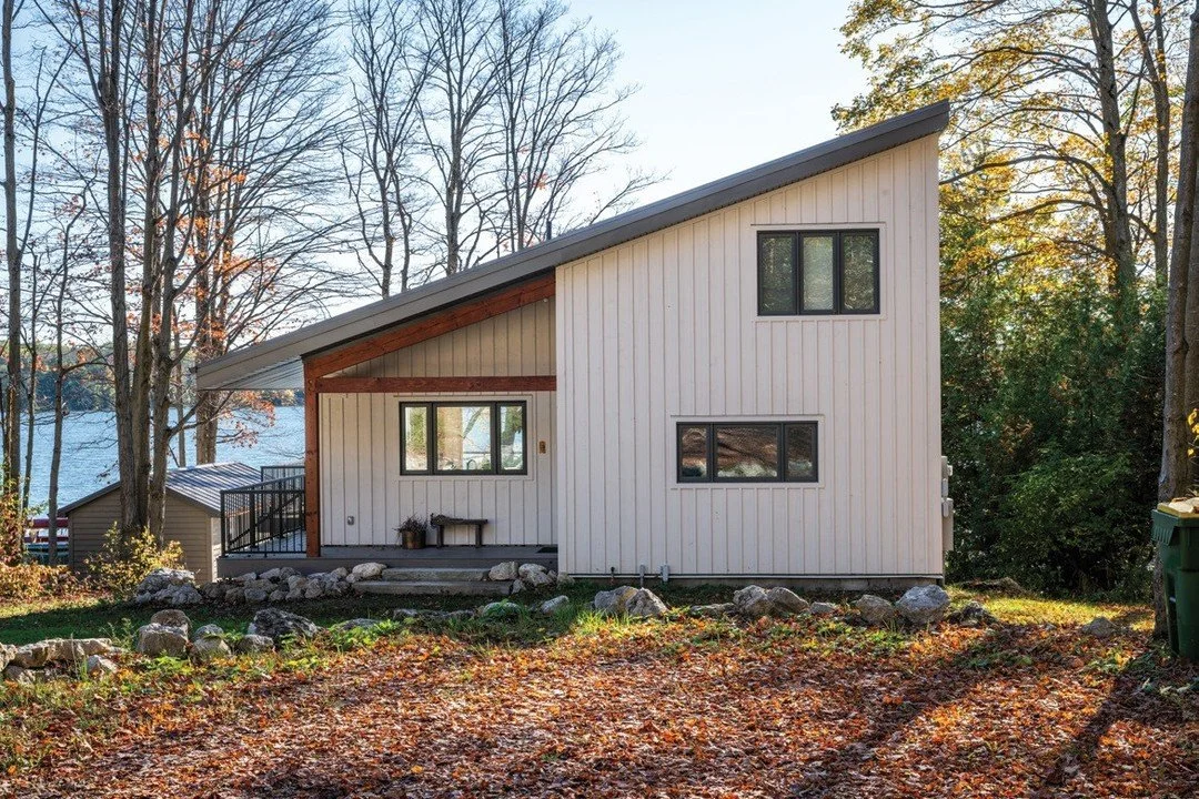 Steps from the shoreline of Lake Eugenia, this asymmetrical family cottage was positioned to capture the view and sunlight on property that had been in the family for generations. The unique exterior is just one of the special touches and design stra