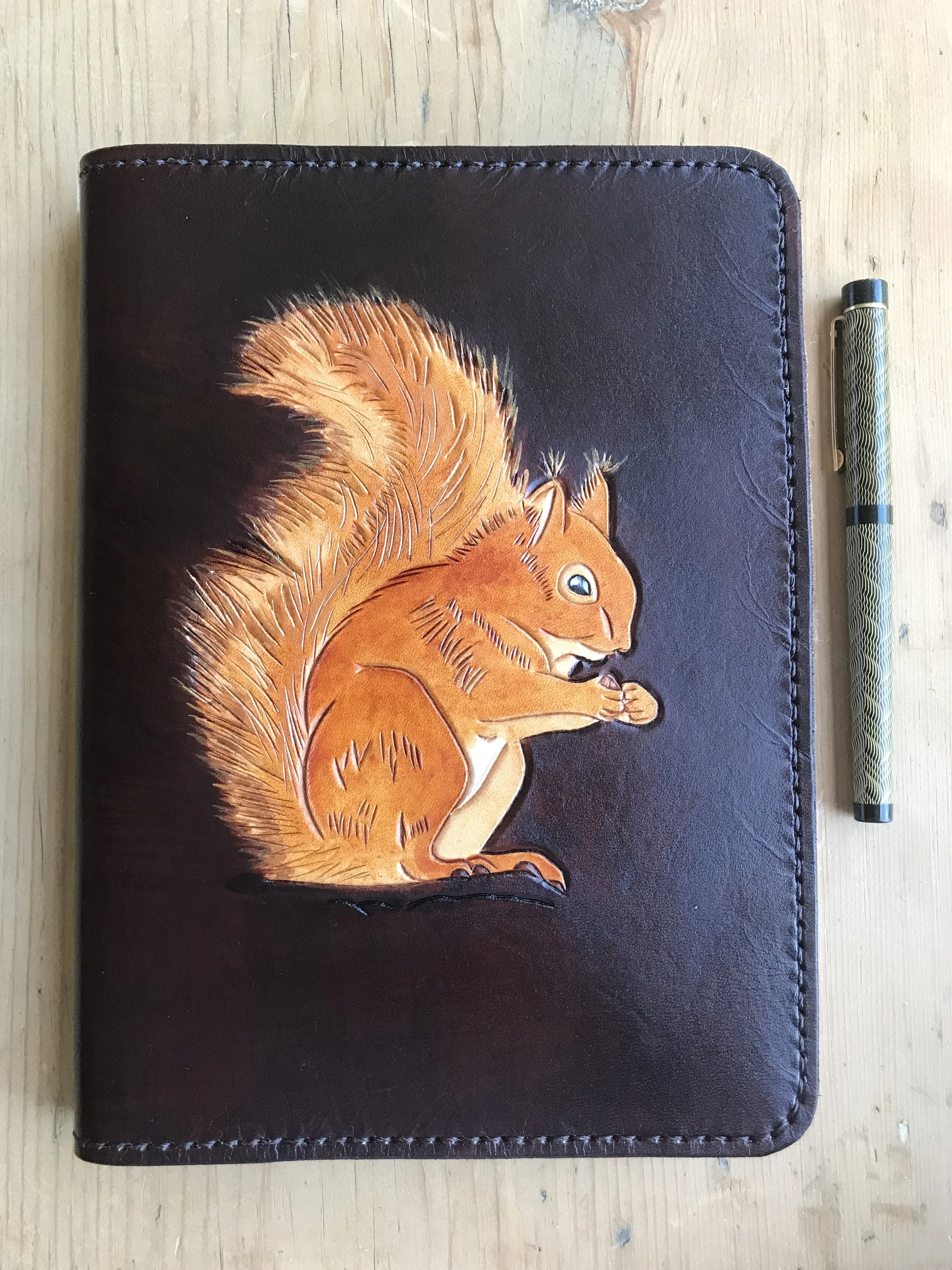 Red squirrel on dark brown A5 leather journal cover