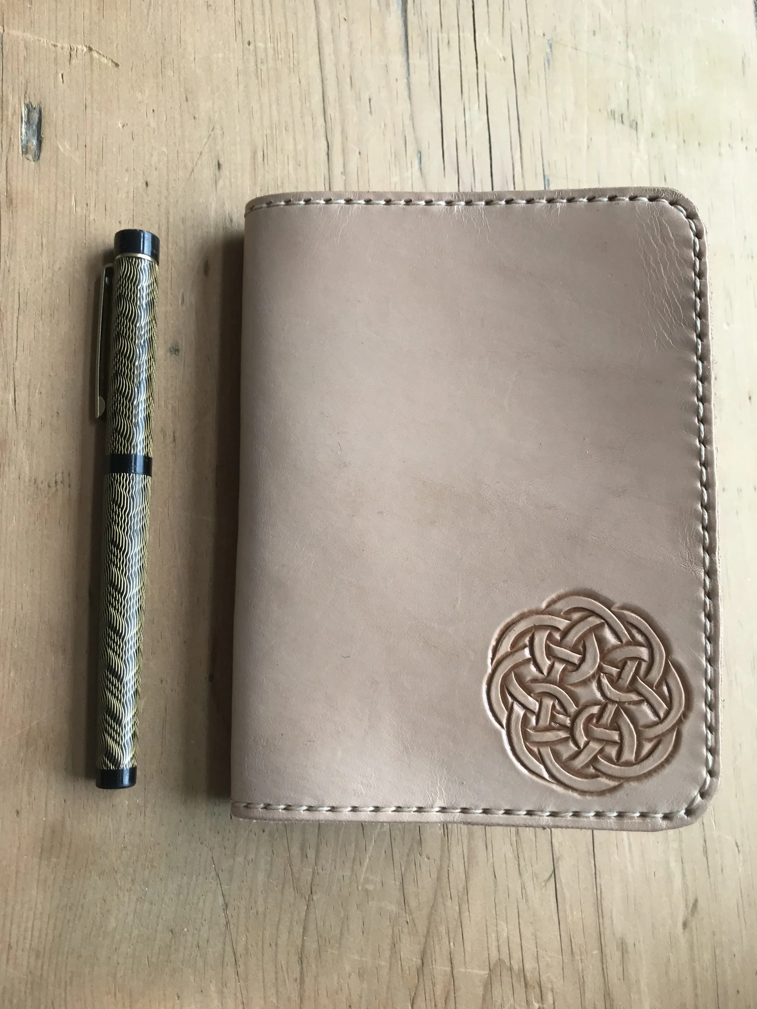 A6 Natural leather refillable notebook cover with mini Celtic knot hand carved in bottom right corner.