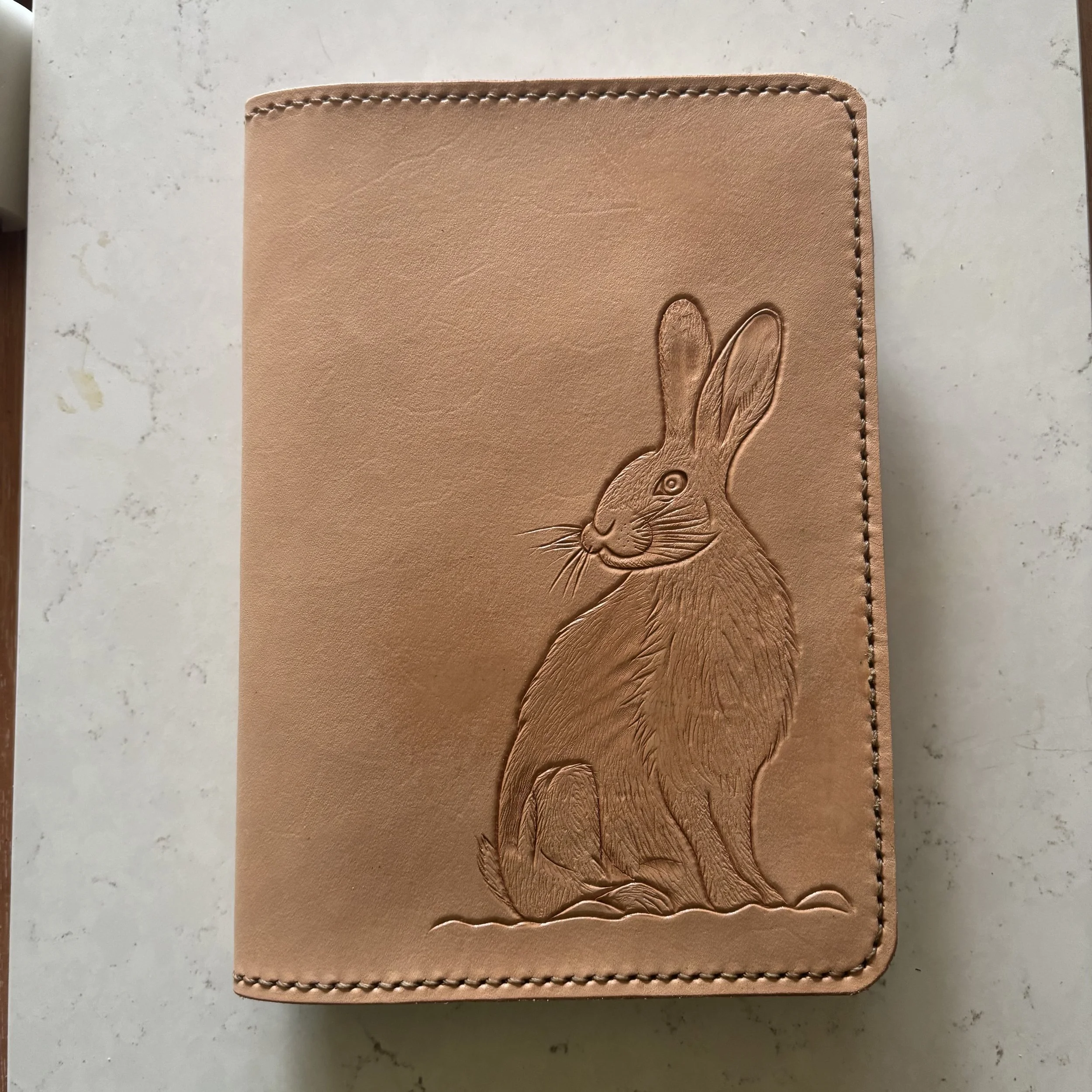 Wild Hare Natural.jpeg A5 journal cover with brown hare, natural (unpainted). Light brown stitching on natural leather.