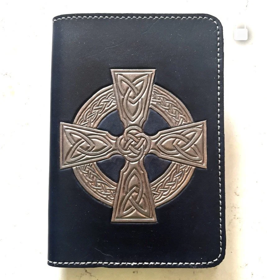 A5 Celtic Cross Silver on Navy.jpeg Refillable leather notebook cover features silver, square Celtic Cross on a navy blue background. Handcarved and painted.