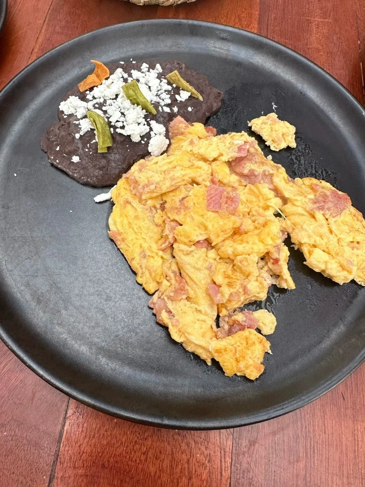 black beans with egg and ham scramble from Tezontle rooftop restaurant at Casa de la Luz hotel, Mexico City