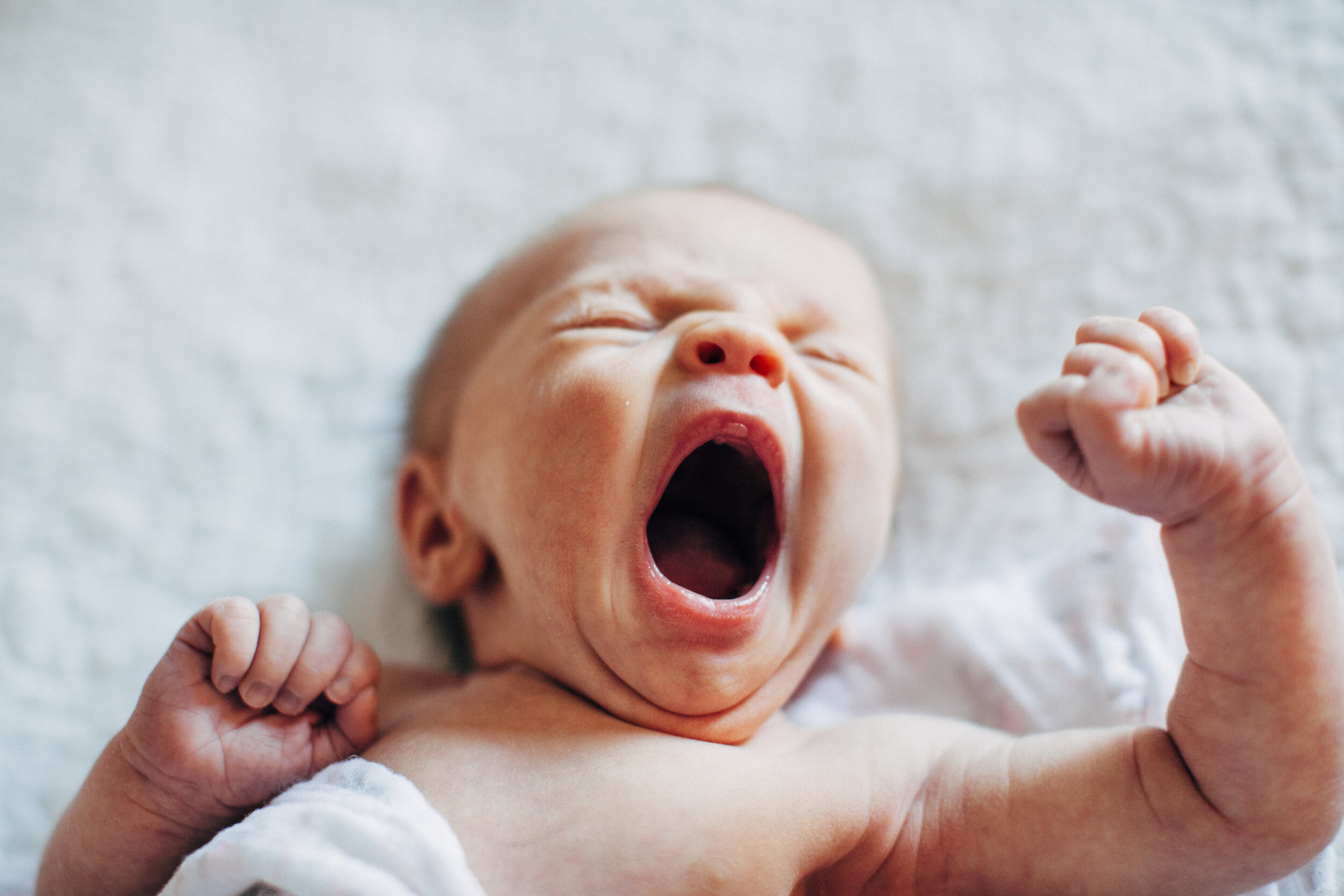 baby yawning on bed.jpg