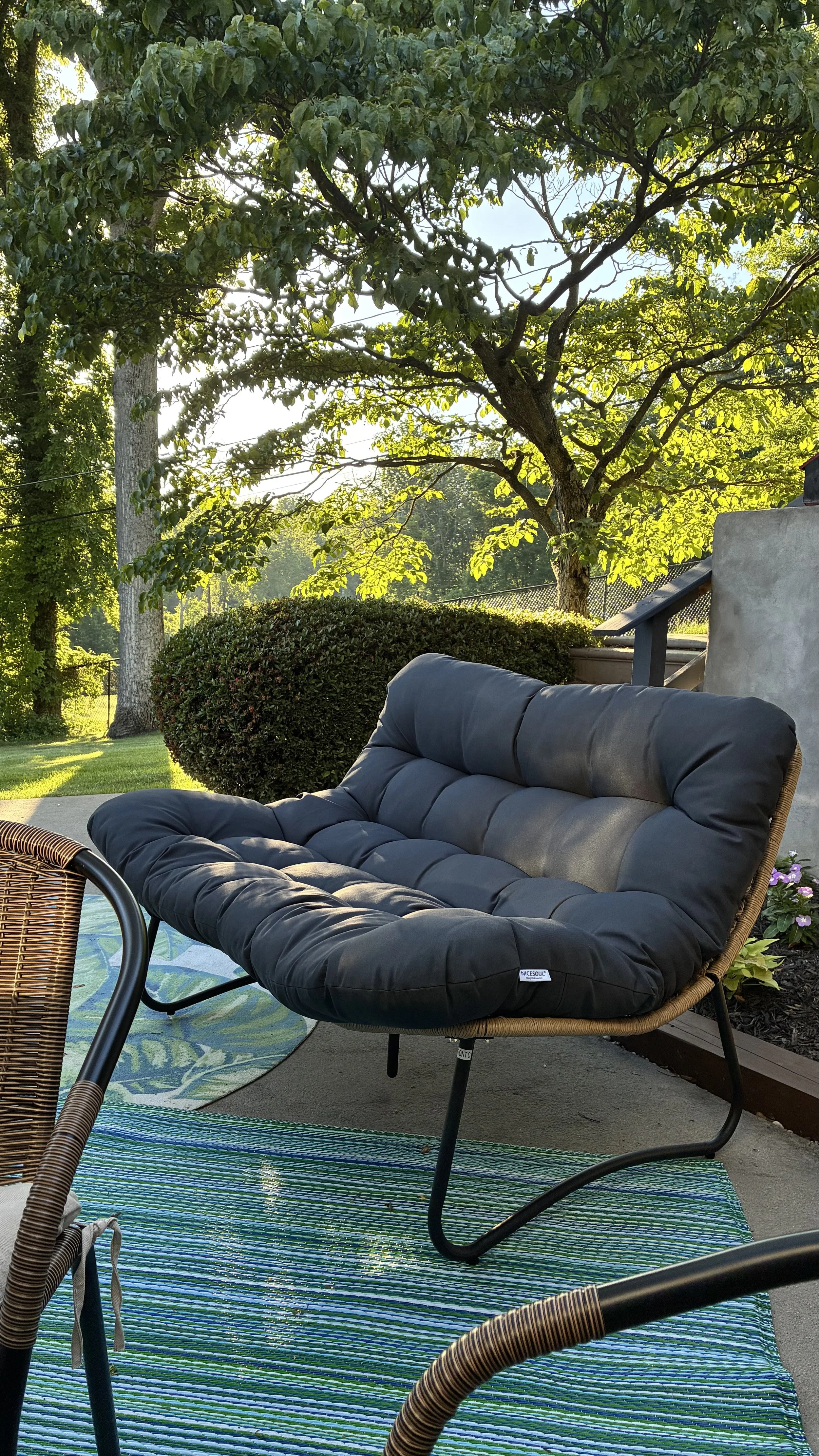 Outdoor papasan loveseat from Wayfair on small patio