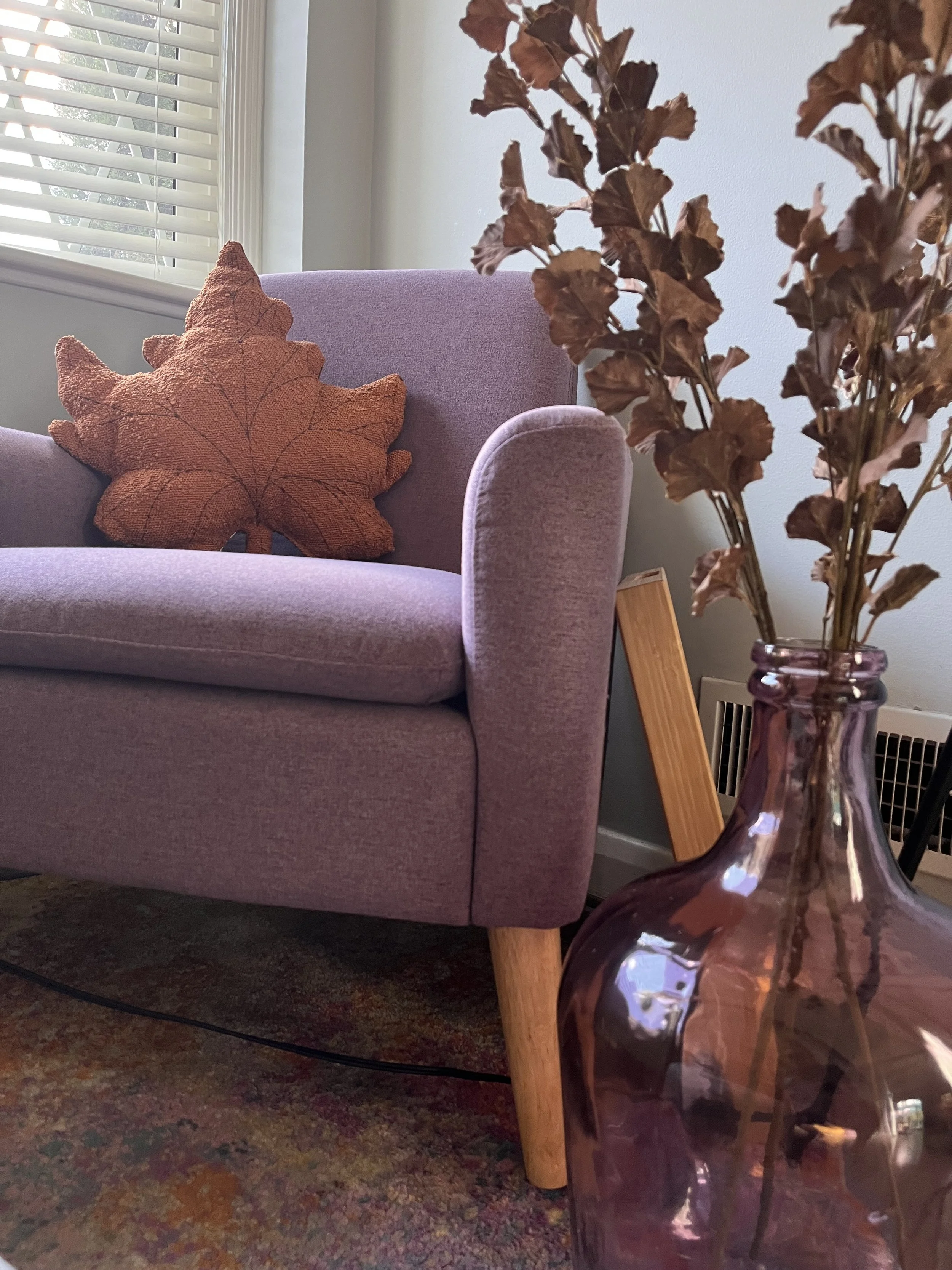 A purple chair with fall decor