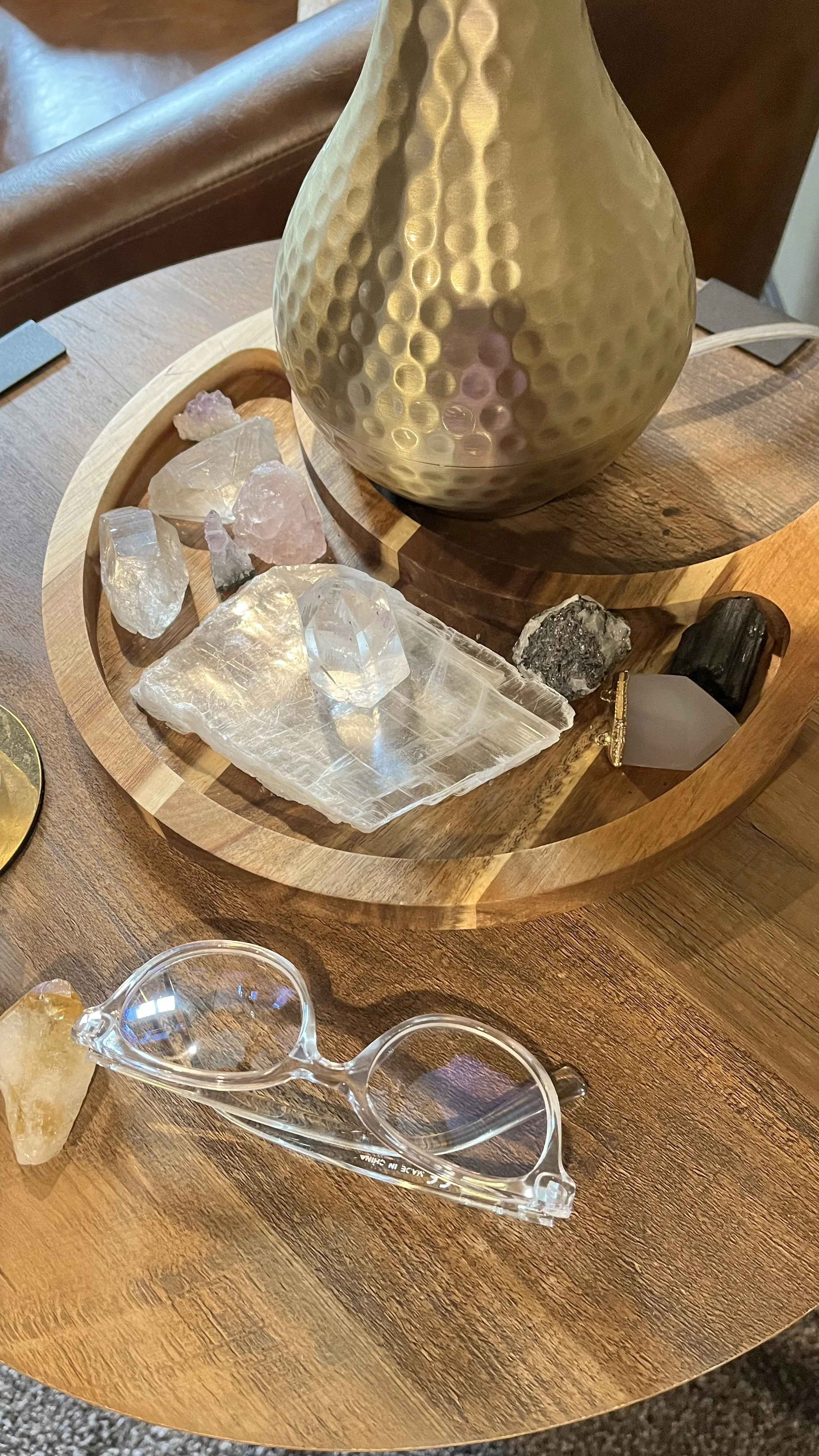 My crystals on a table near my glasses.