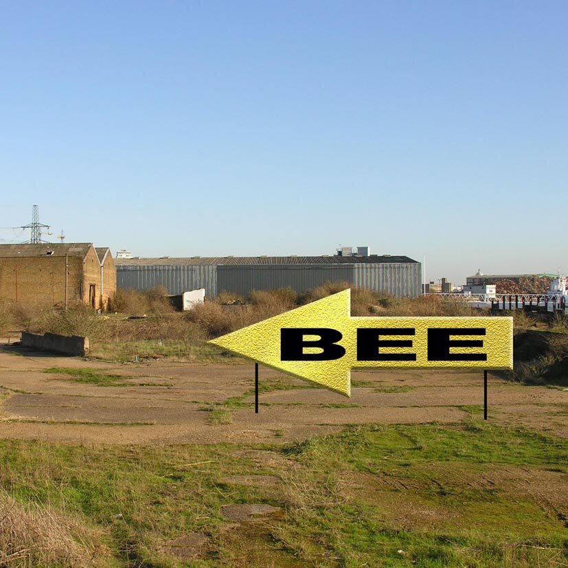 Huge BEE sign on inaccessible brown field site in East London.
