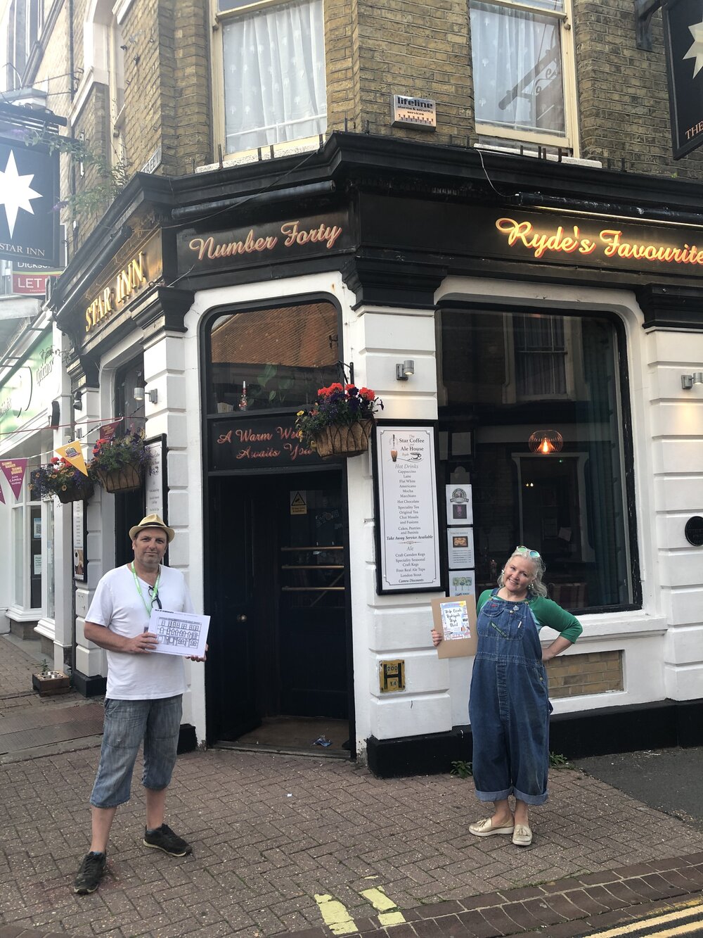 Photo of Theresa and Rob, the owner of The Star Coffee and Ale House, in front of his pub, one of the Rydesgate buildings