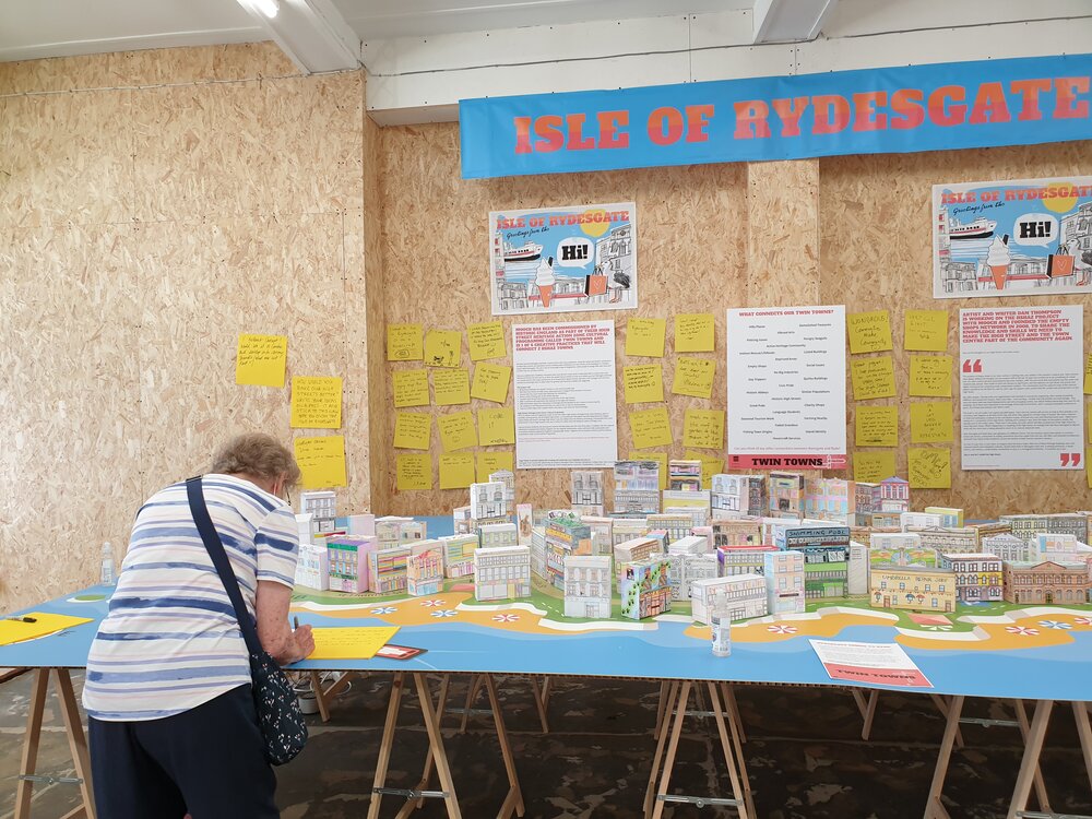Photo of a visitor writing a comment card at the Ryde exhibition