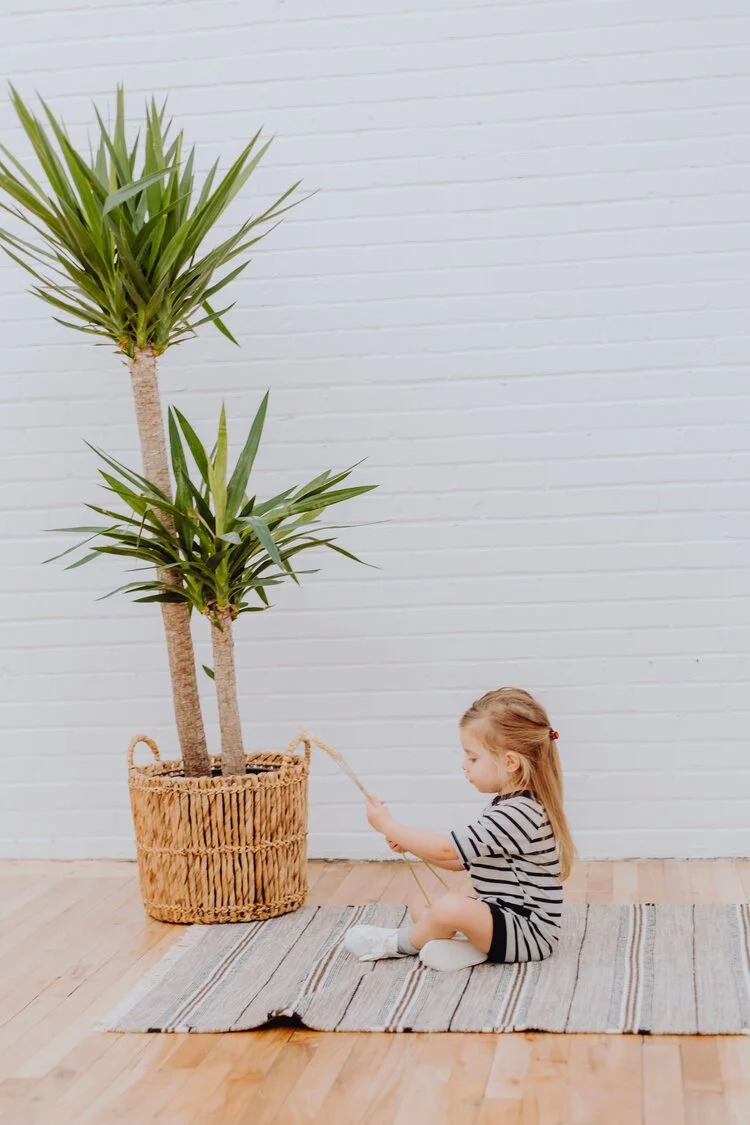 Fillette qui joue près de plantes