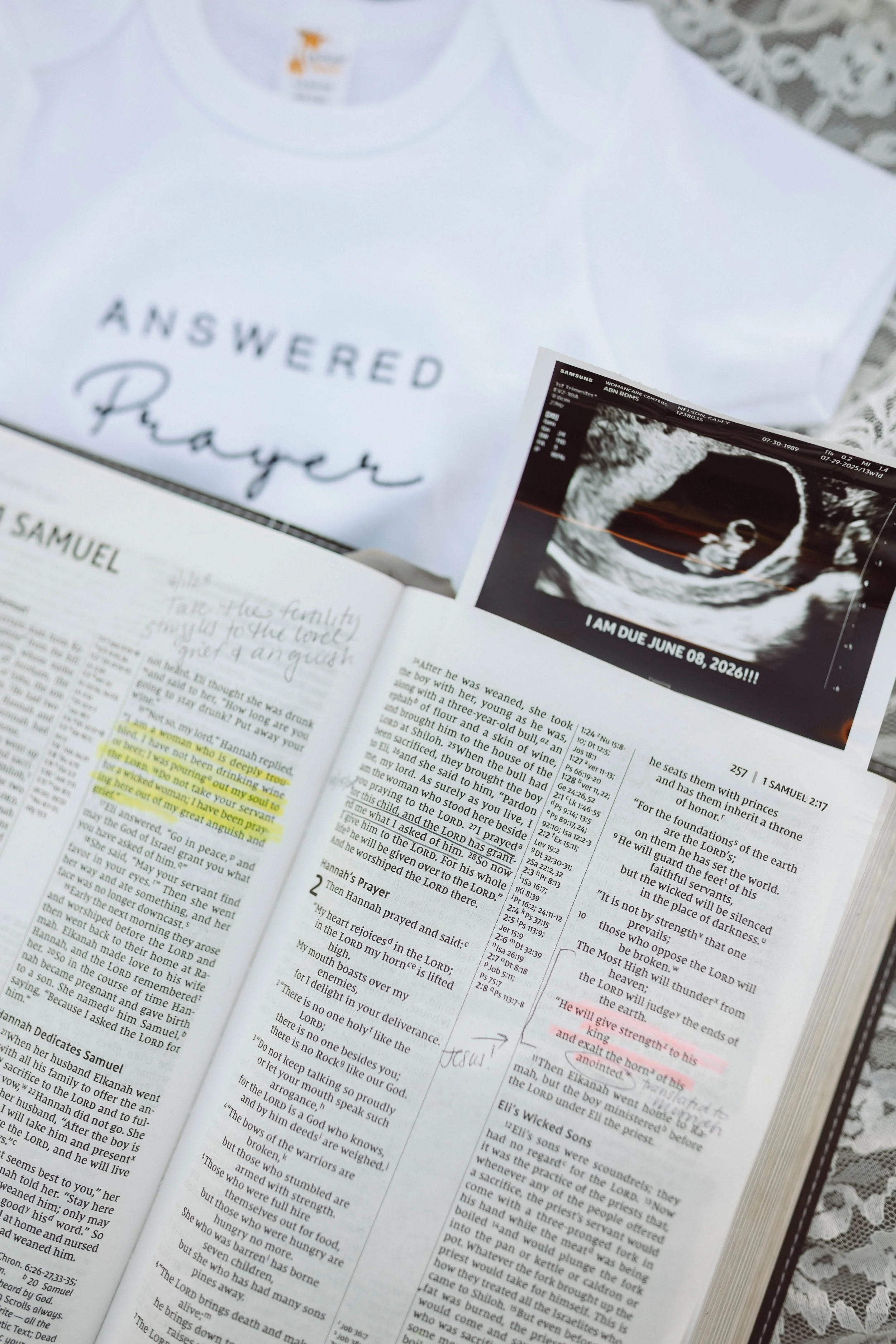 virginia beach navy couple holds miracle baby onesie standing at virginia beach north end