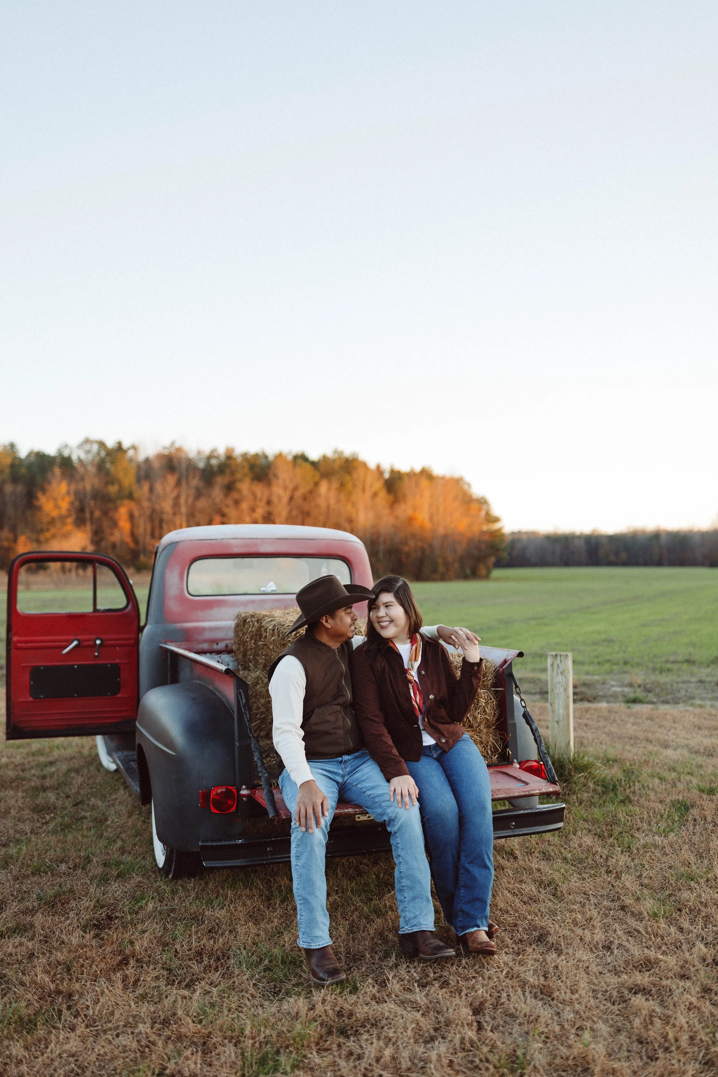 couple embraces in the back of an antique ford pickup truck