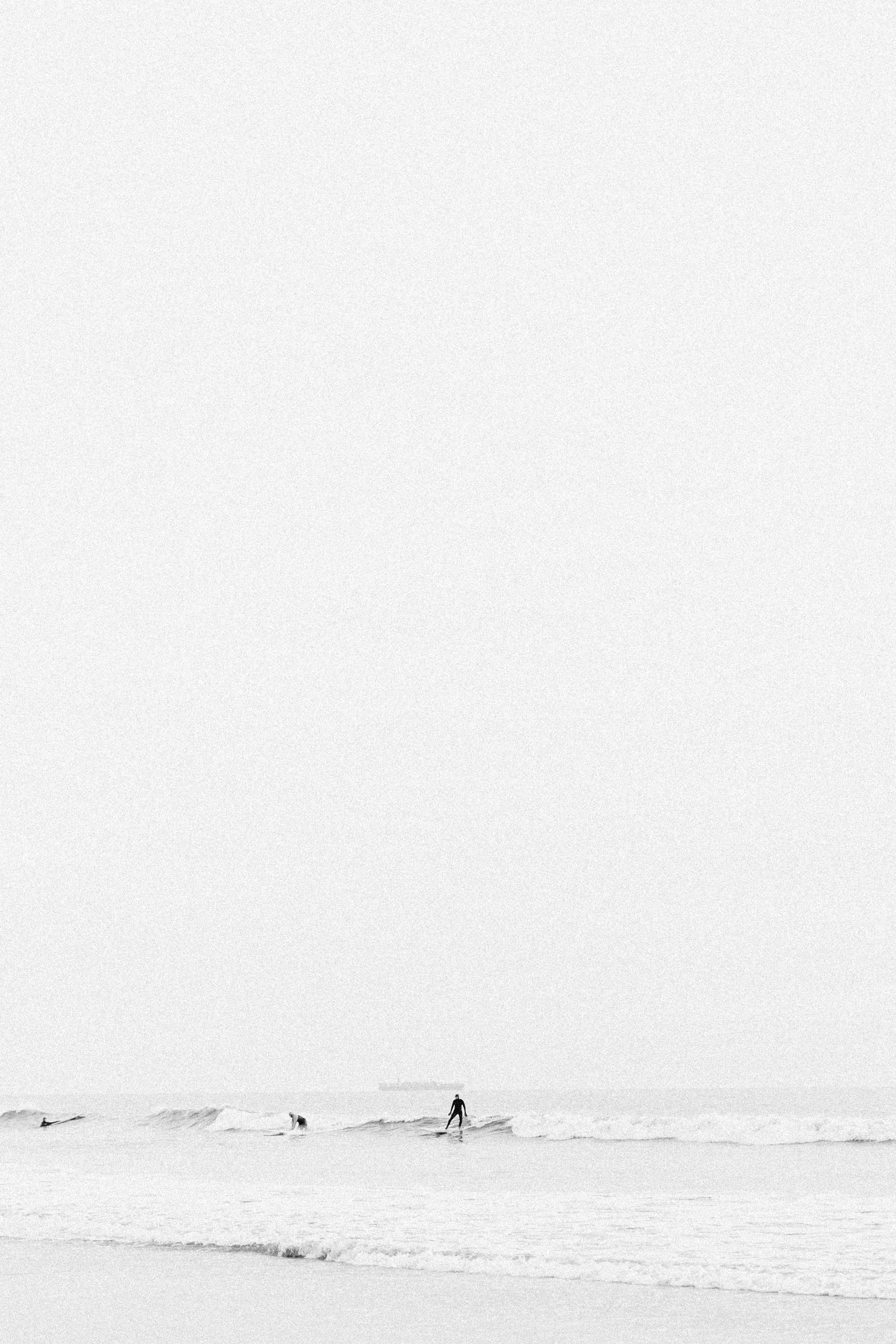 black and white image of surfers