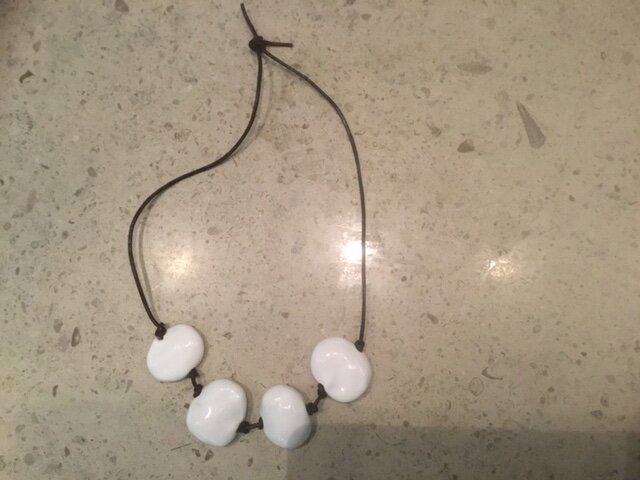 Large Flat White Beads on Brown Leather