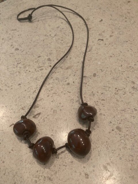 Iron Ore Hand Fired Beads on Brown Leather