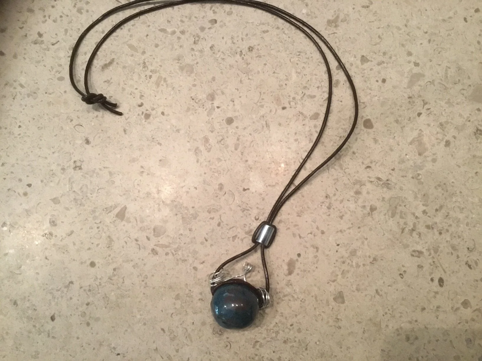 Silver wire & fitting, tourquoise bead on brown leather $45.JPG