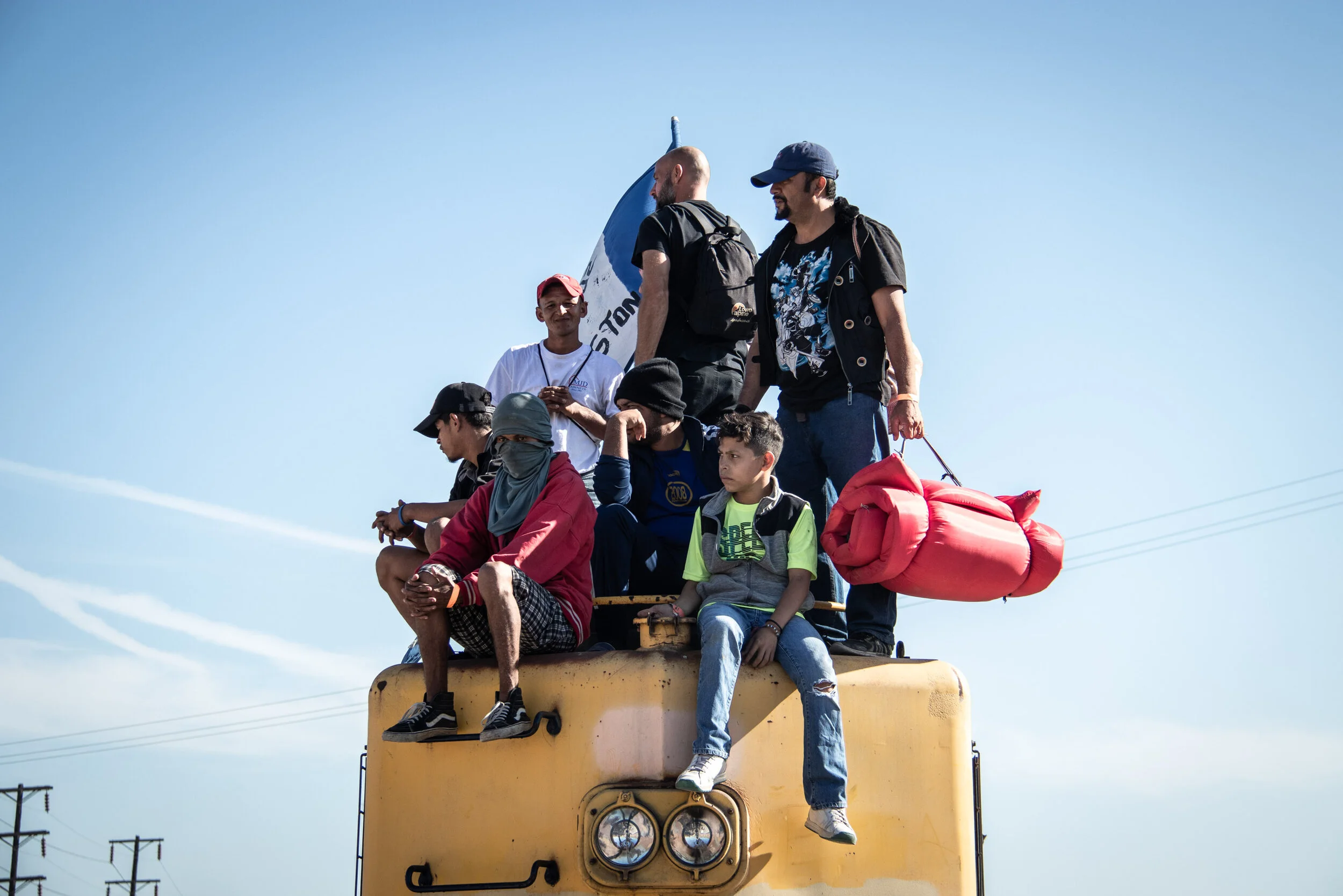  Members of the Honduran Migrant Caravan stand atop a train on the US-Mexico border.   November, 25th, 2018 