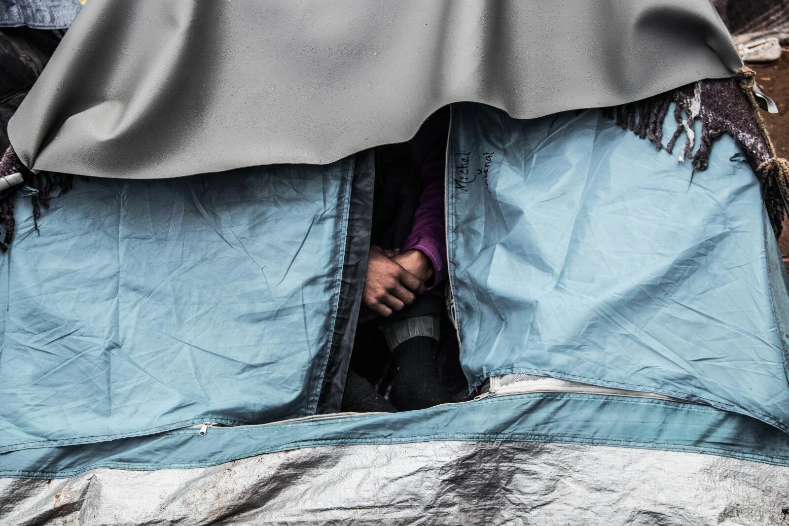  A member of the migrant caravan takes shelter in his tent in Tijuana, Mexico as he waits for his asylum application to be reviewed.   November, 2018 