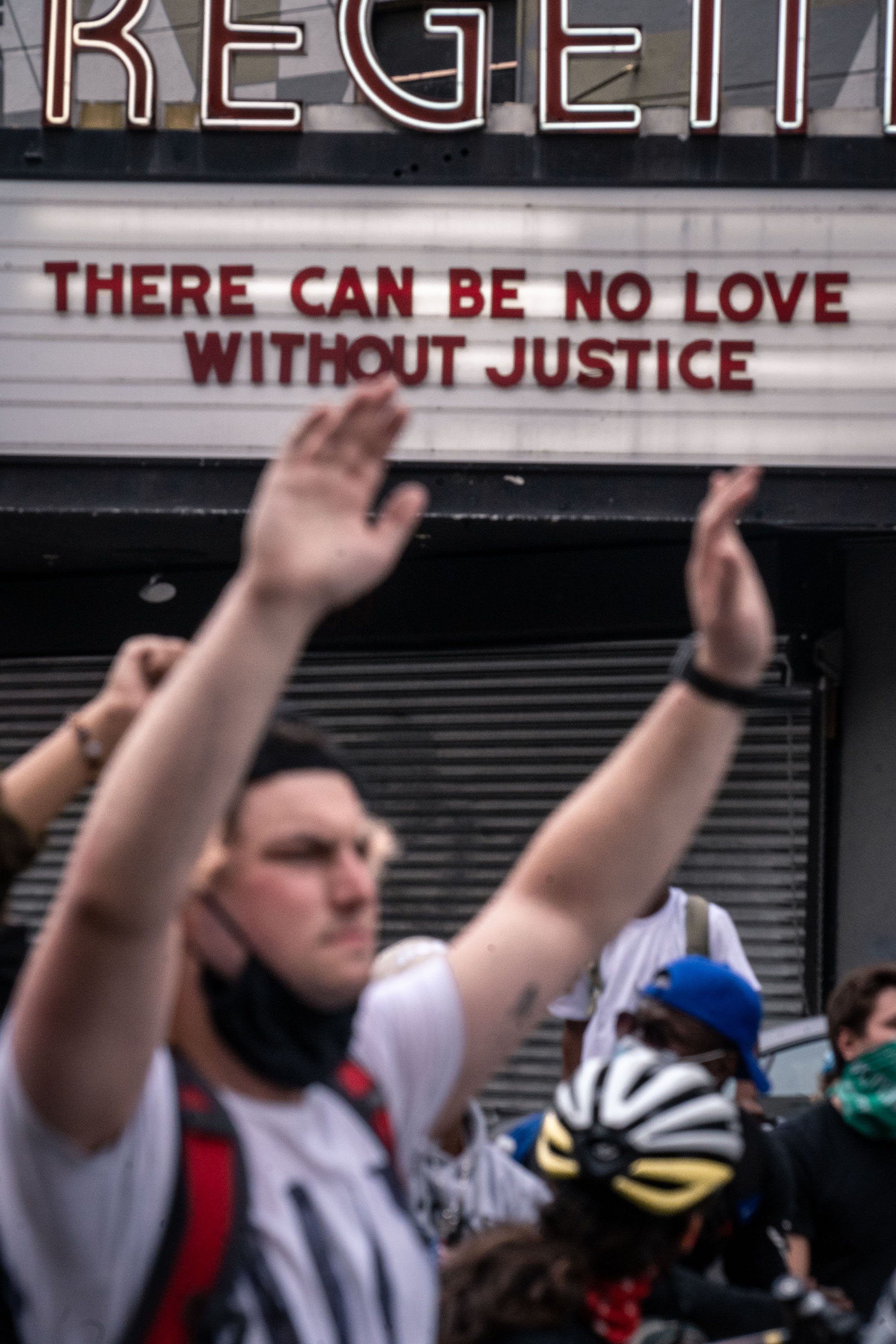 Protesters halt in front of a theatre in Los Angeles before being arrested for violating curfew.     June 4, 2020 