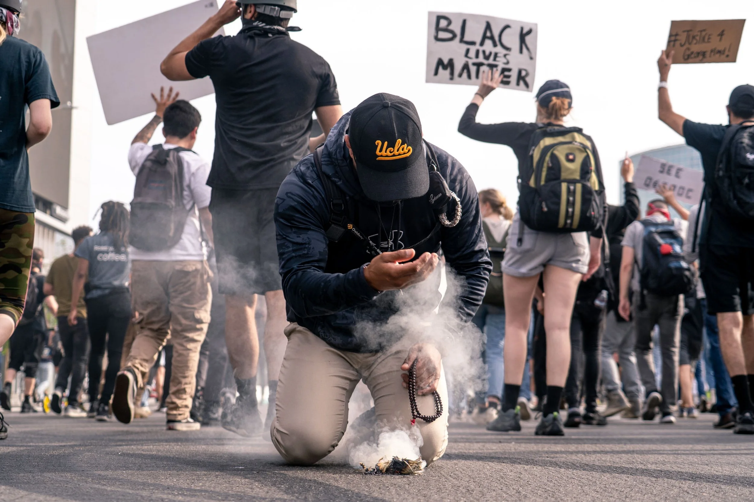  A protestor blesses a BLM march with sage smoke in downtown Los Angeles.  June 3, 2020 