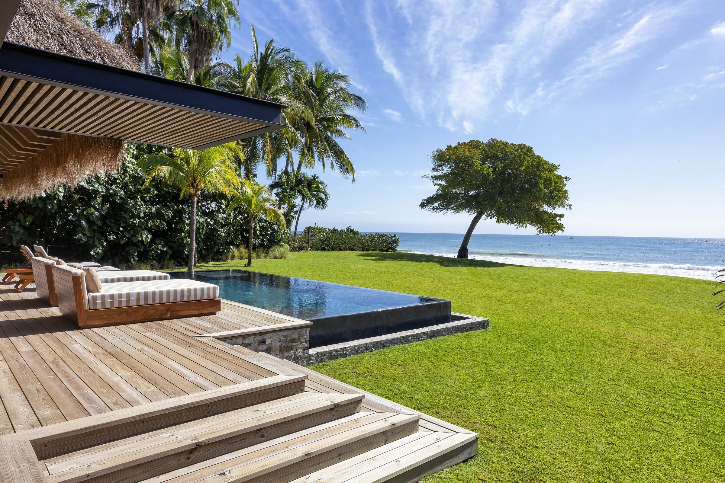 The beach cabana deck and lawn meeting the sand on Ranchos 15