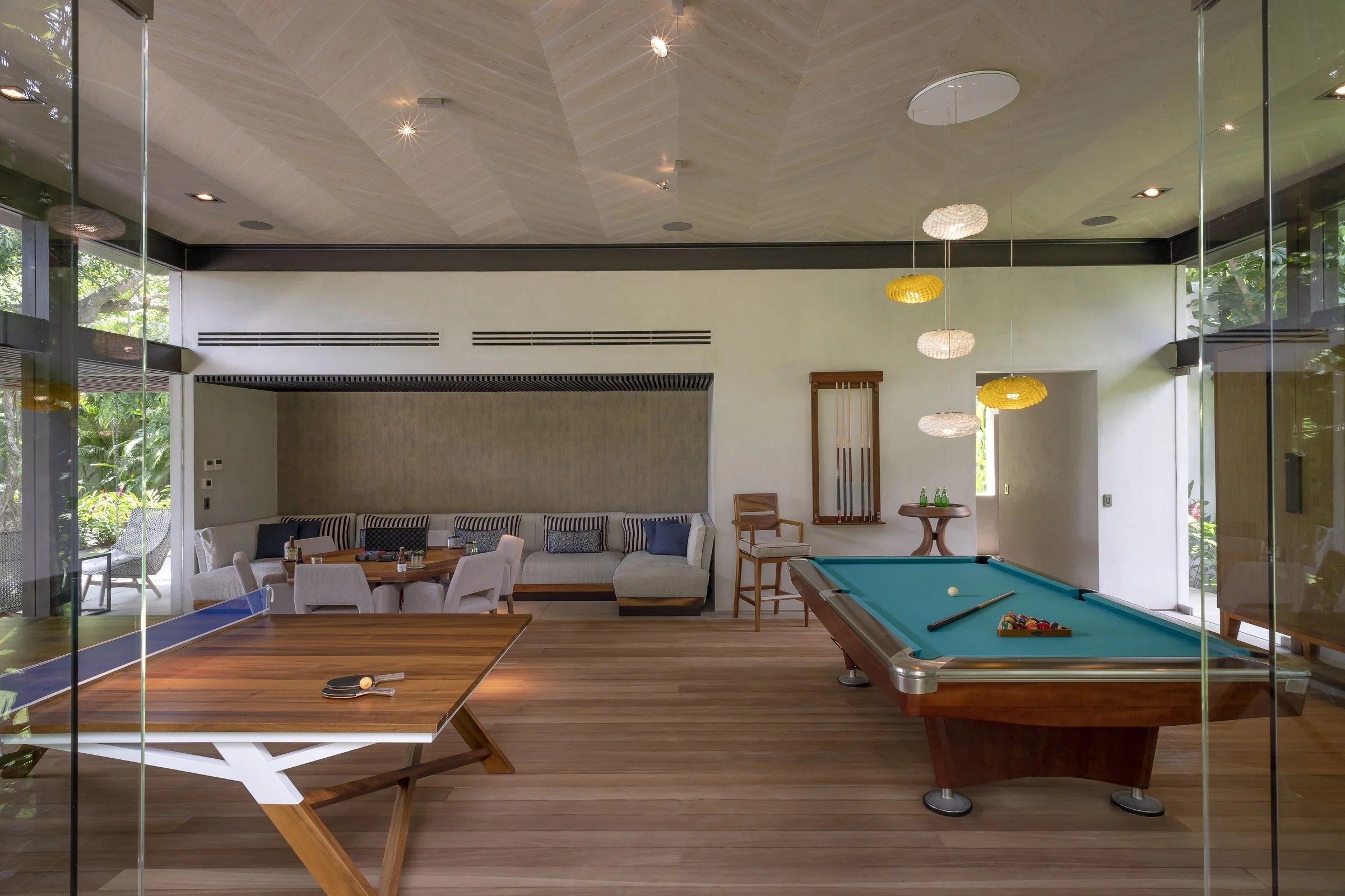 The glass-walled game pavilion with ping-pong and billiards tables