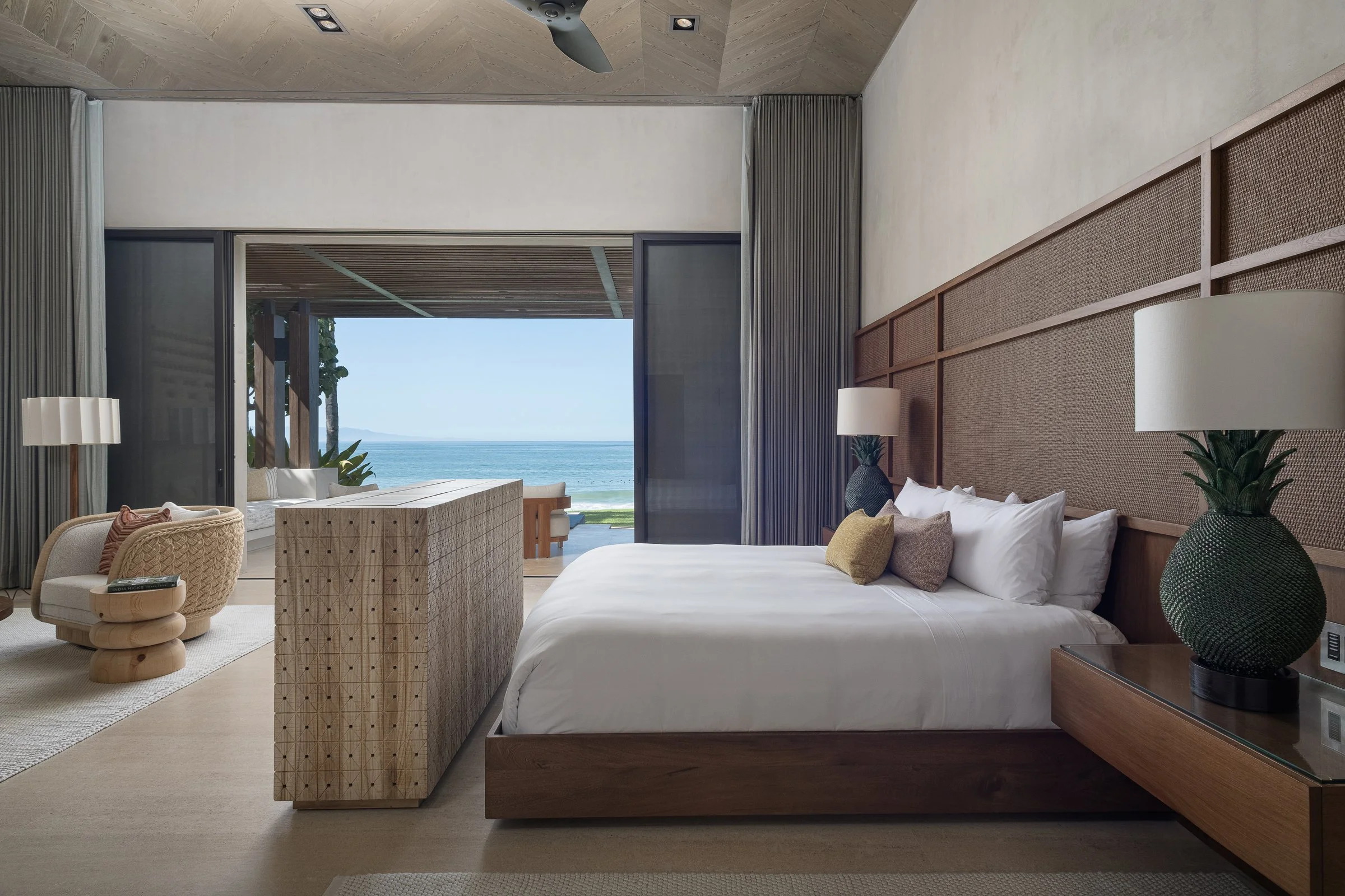 A master suite with the ocean framed in the open doors