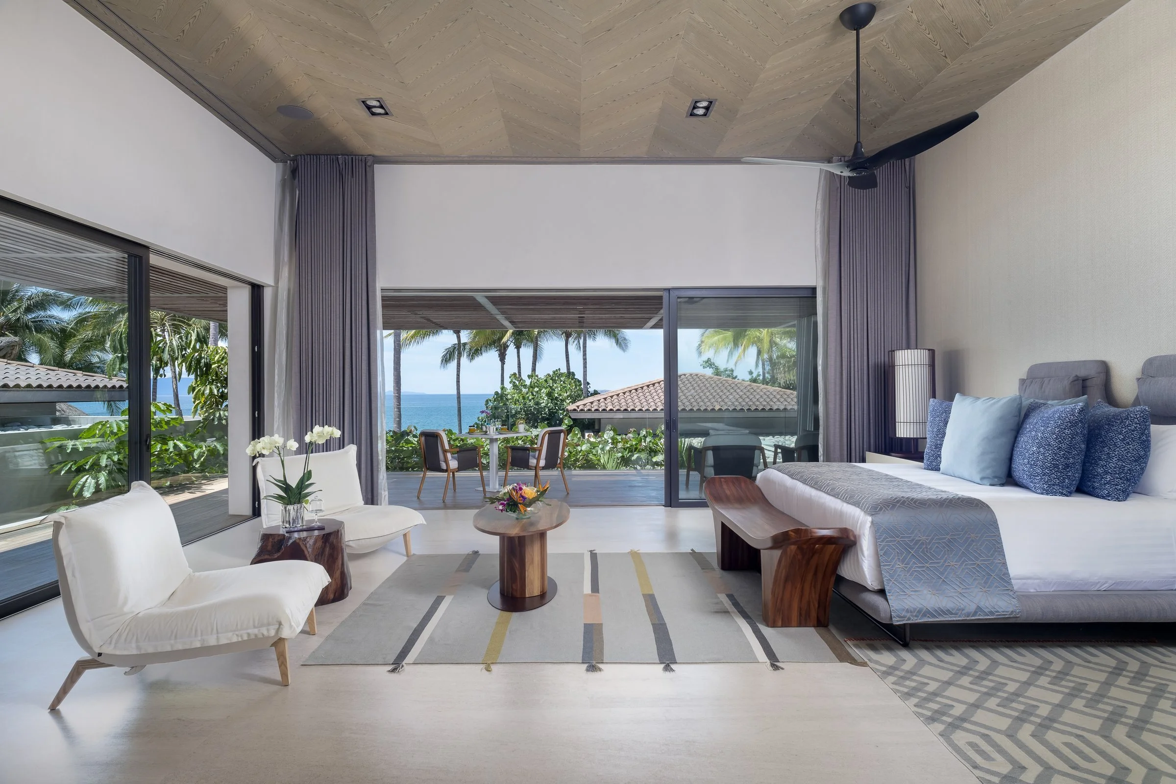 The Balcony Suite — King bed and lounge opening to a private balcony