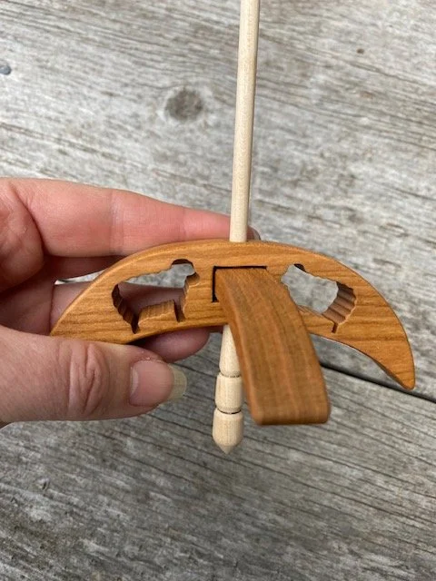 turkish drop spindle with cut outs.jpg
