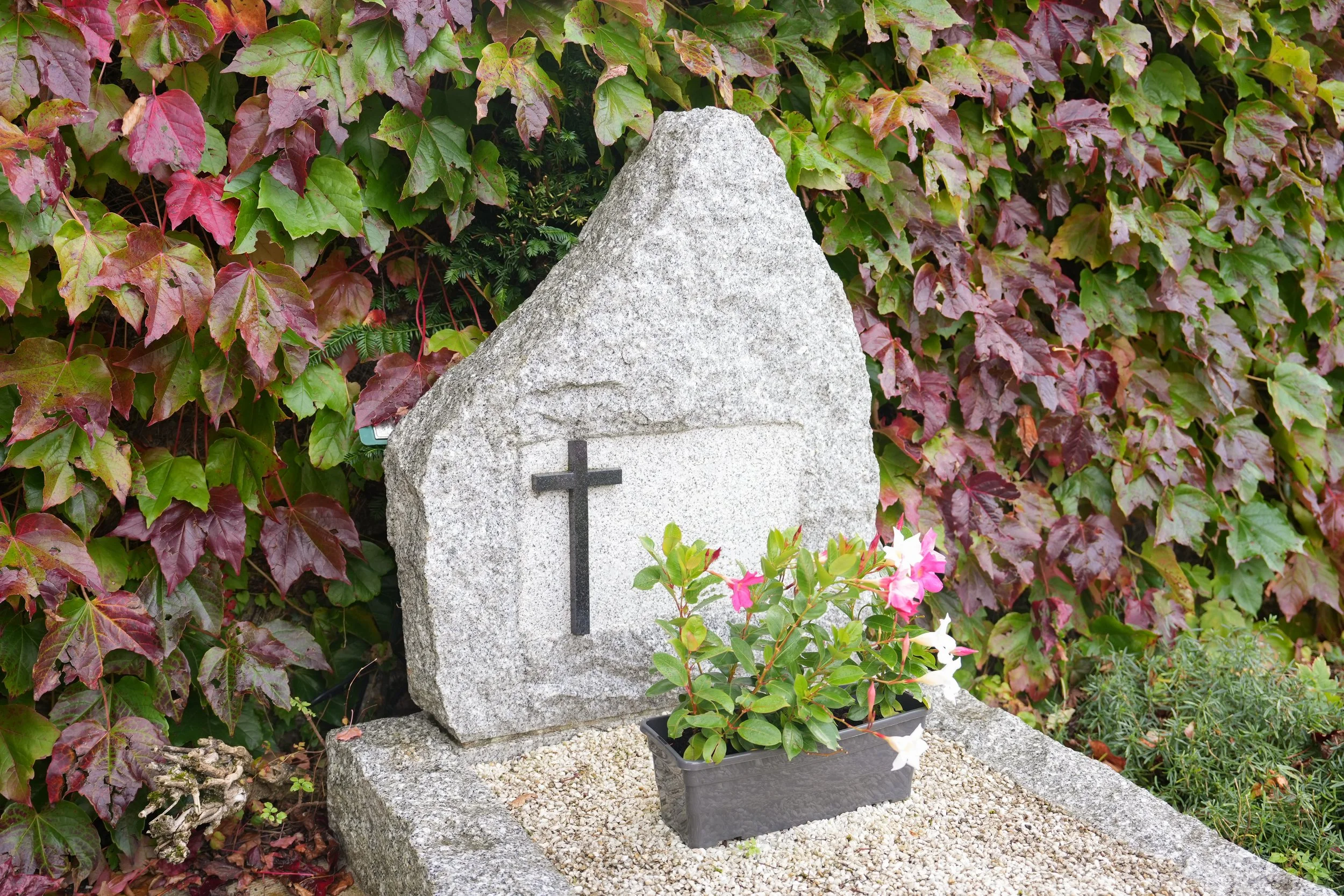 cross-on-a-stone-marble-slab-on-a-grave-in-a-cemet-2026-03-25-03-31-01-utc.jpg