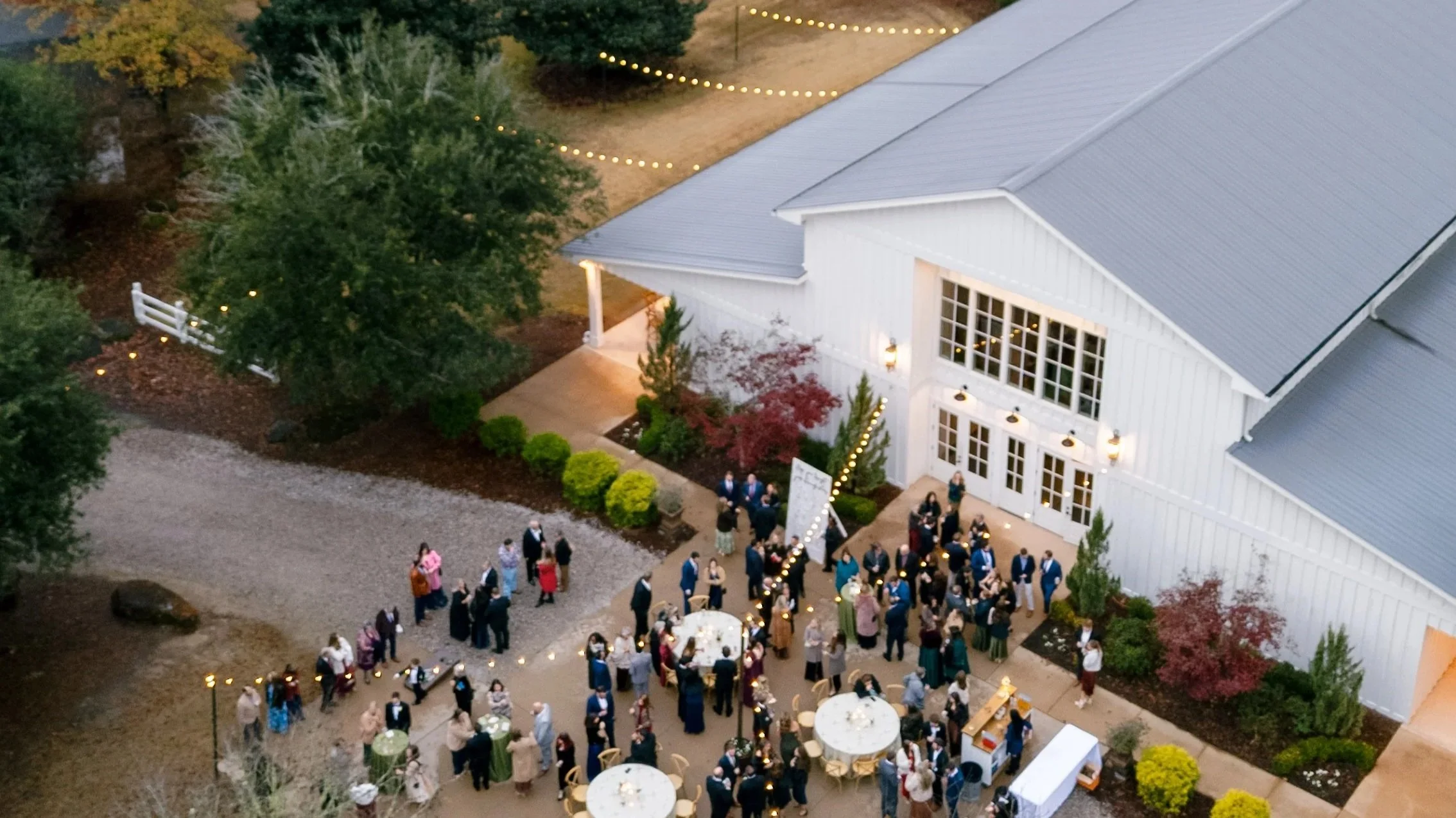 AERIAL OF COCKTAIL HOUR ON CLUBHOUSE PATIO AT AUBURN OAKS FARM