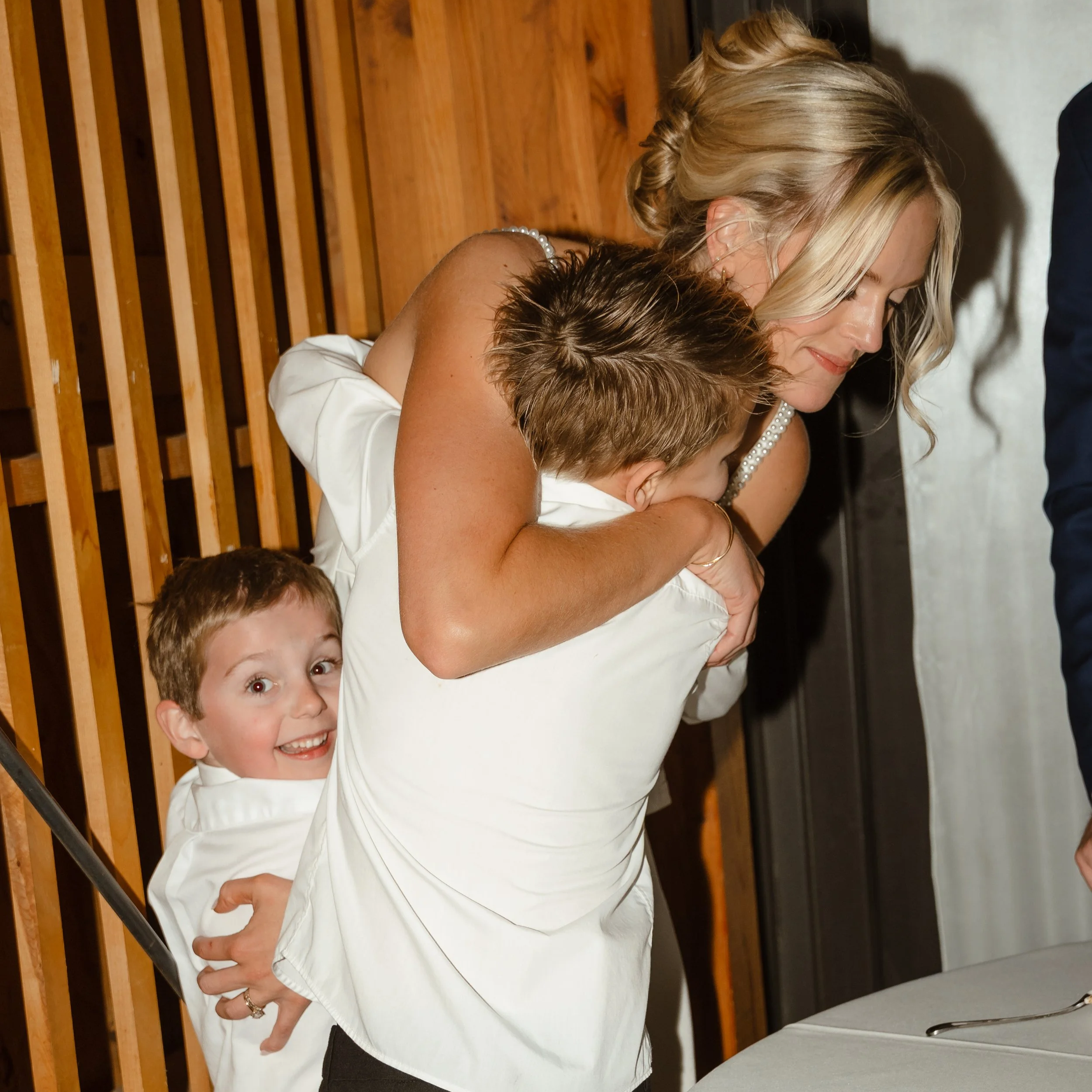 bride hugging ring bearer
