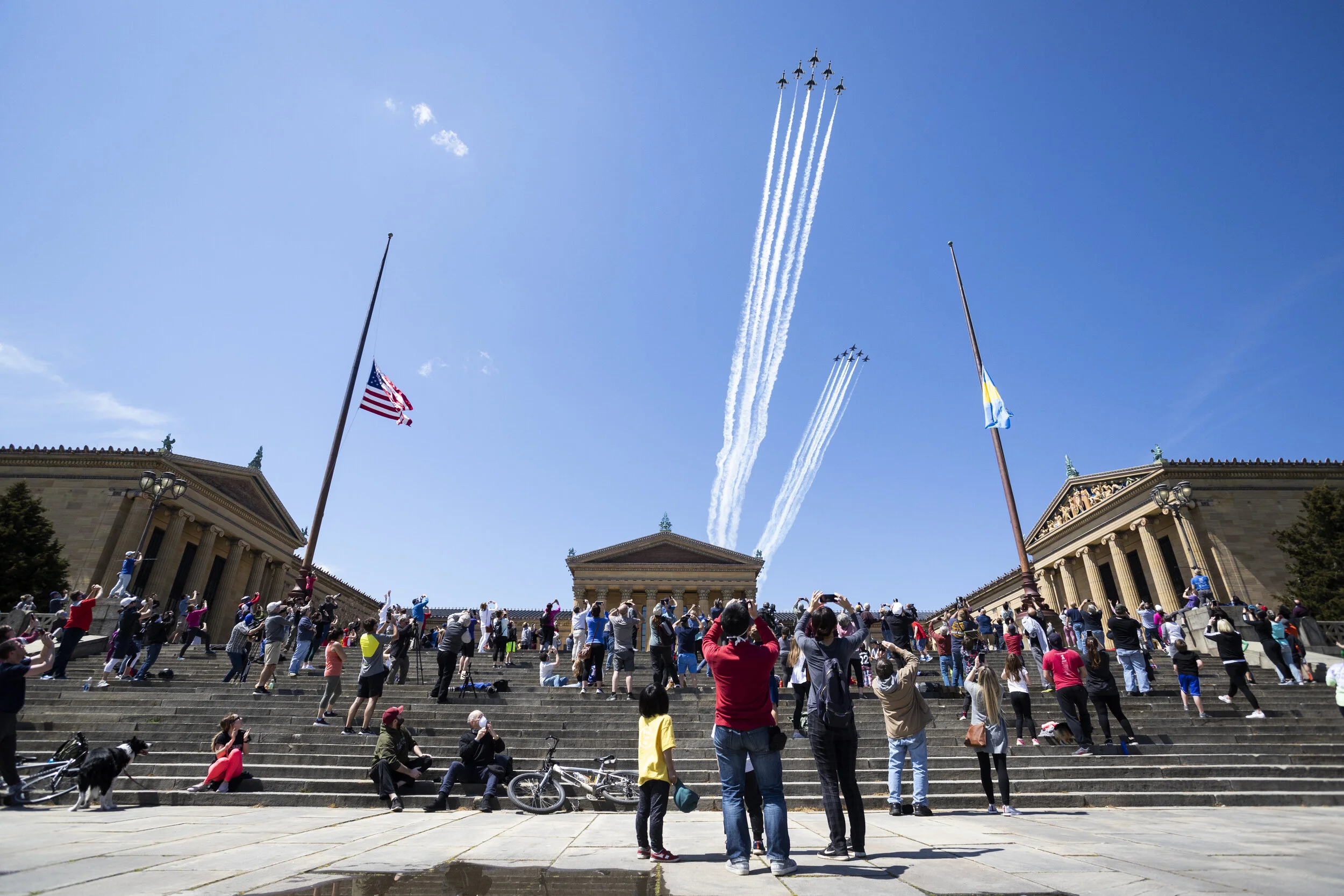  Onlookers crowd the steps of the Philadelphia Museum of Art as the USAF Thunderbirds and US Navy Blue Angels pass overhead in support of frontline workers fighting against coronavirus.    