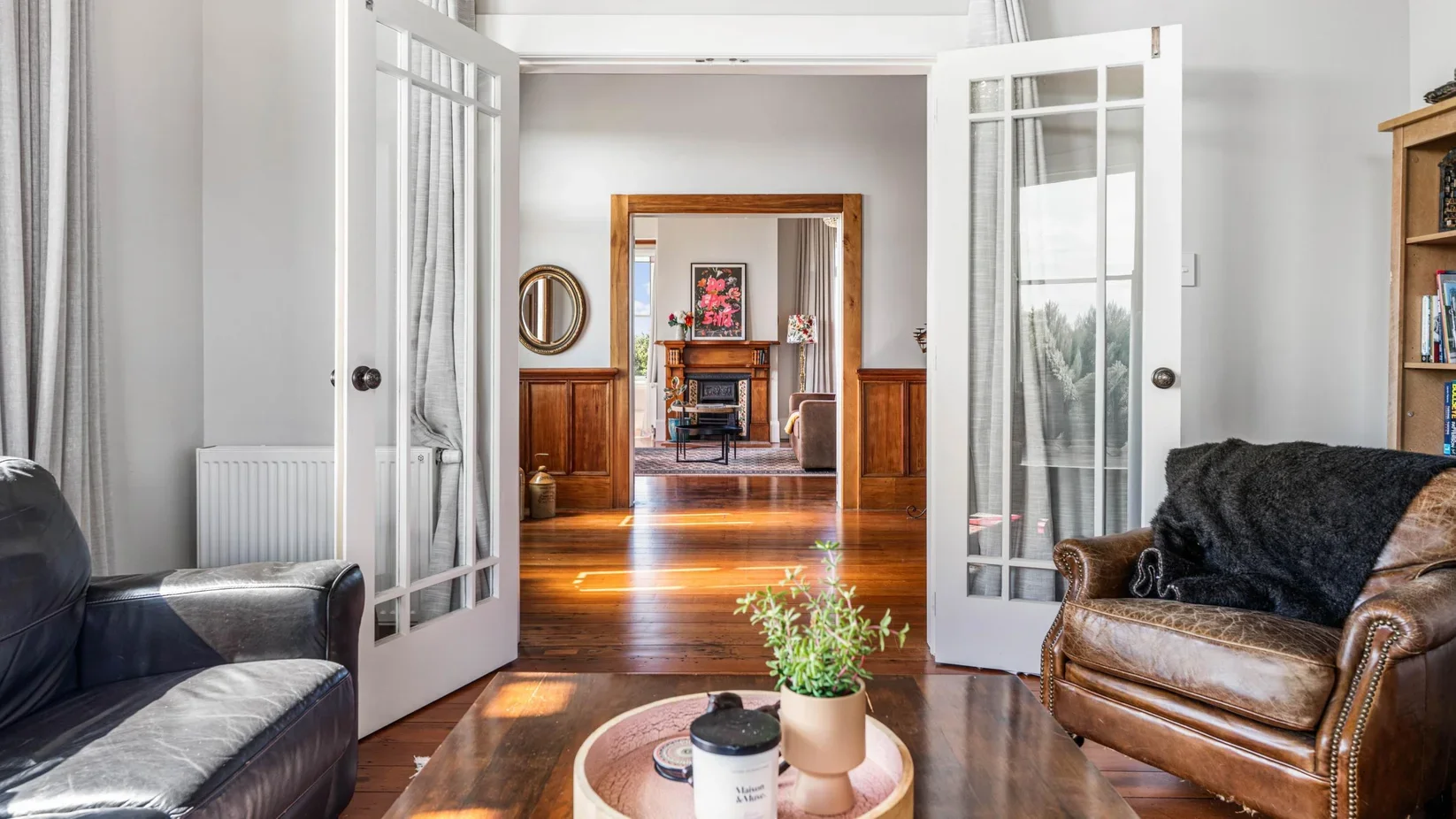 Traditional timber interior French doors and restored villa hallway joinery in the early-1900s home at 111 Wharf Road.