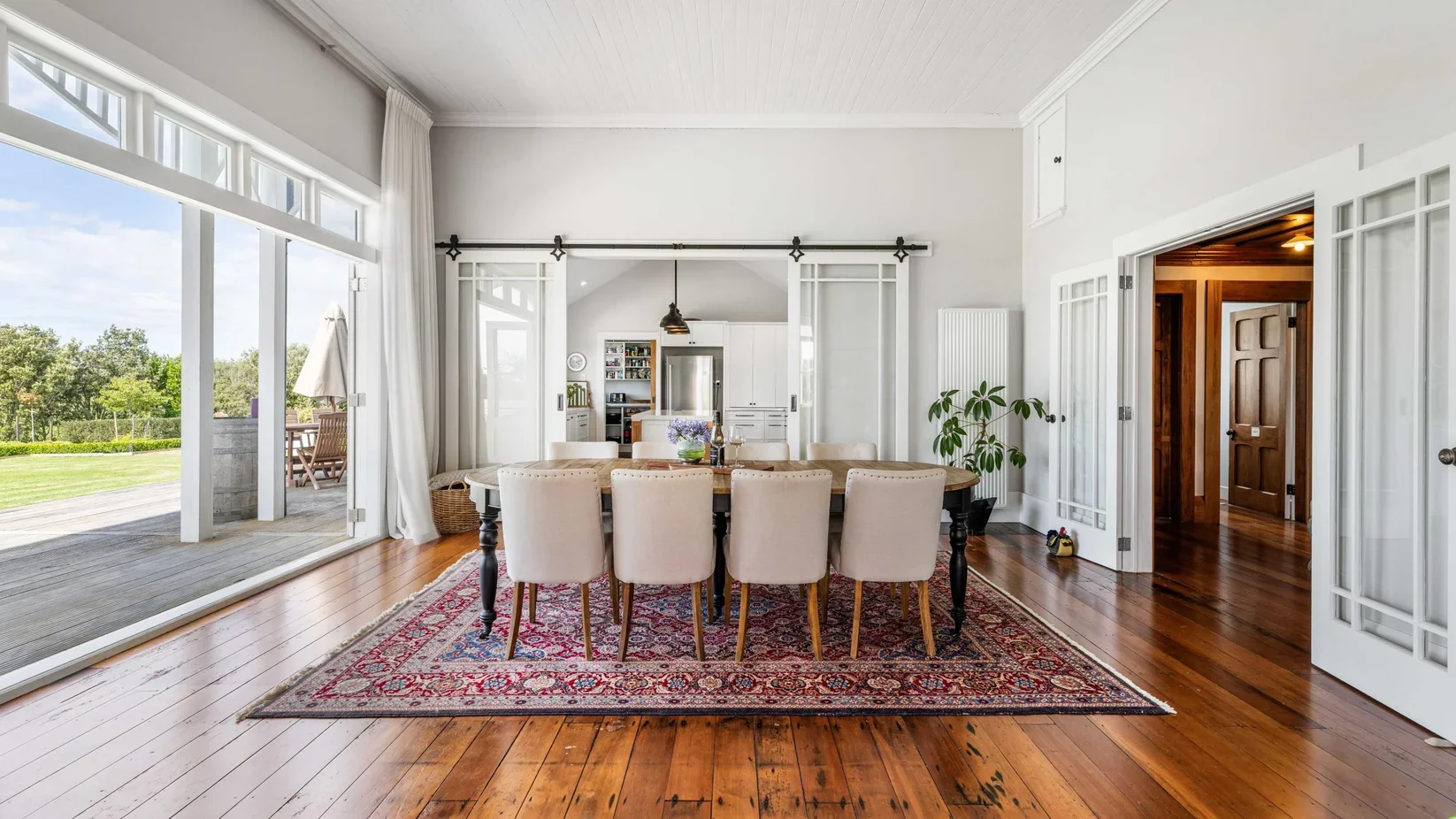 Heritage timber French doors and sliding kitchen doors in the dining room of the restored villa at 111 Wharf Road, Clarkes Beach.