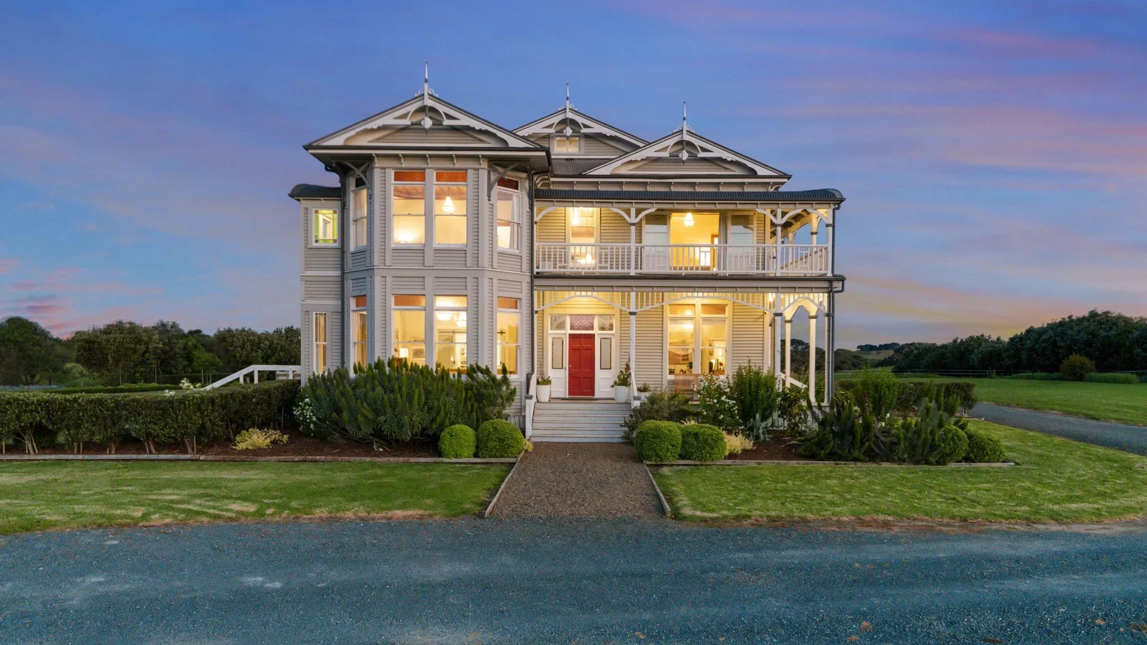 Heritage weatherboard villa at Clarkes Beach with traditional timber joinery, double-hung windows and period detailing manufactured by Dando Doors and Windows.