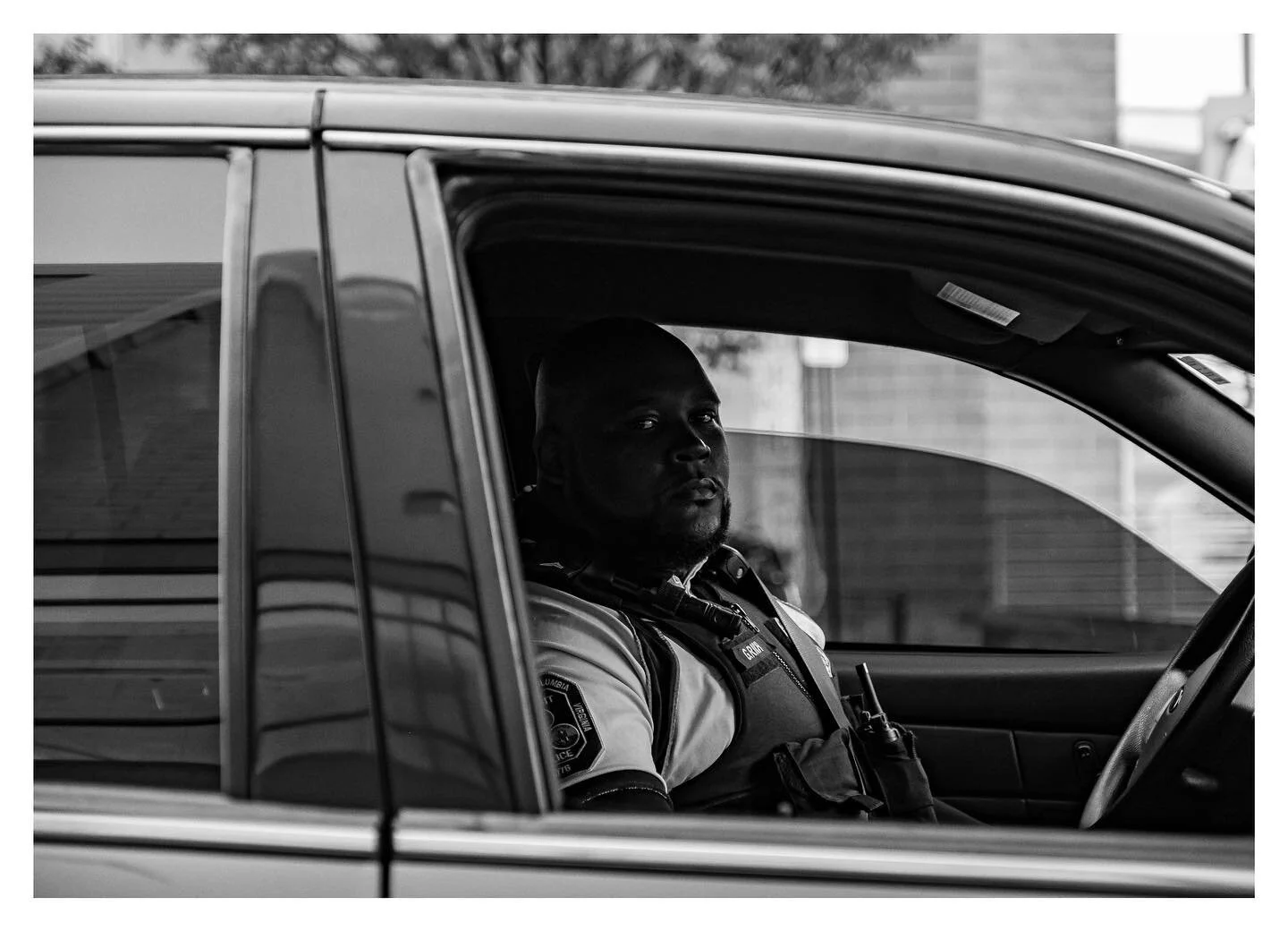 A police officer waits for his partner outside of the Streets Market Cafe on 14th street and two construction workers direct traffic off of 16th street near Meridian Hill Park. 
.
.
.
#photo #photography #streetphotography #photojournalism #fujifilm 