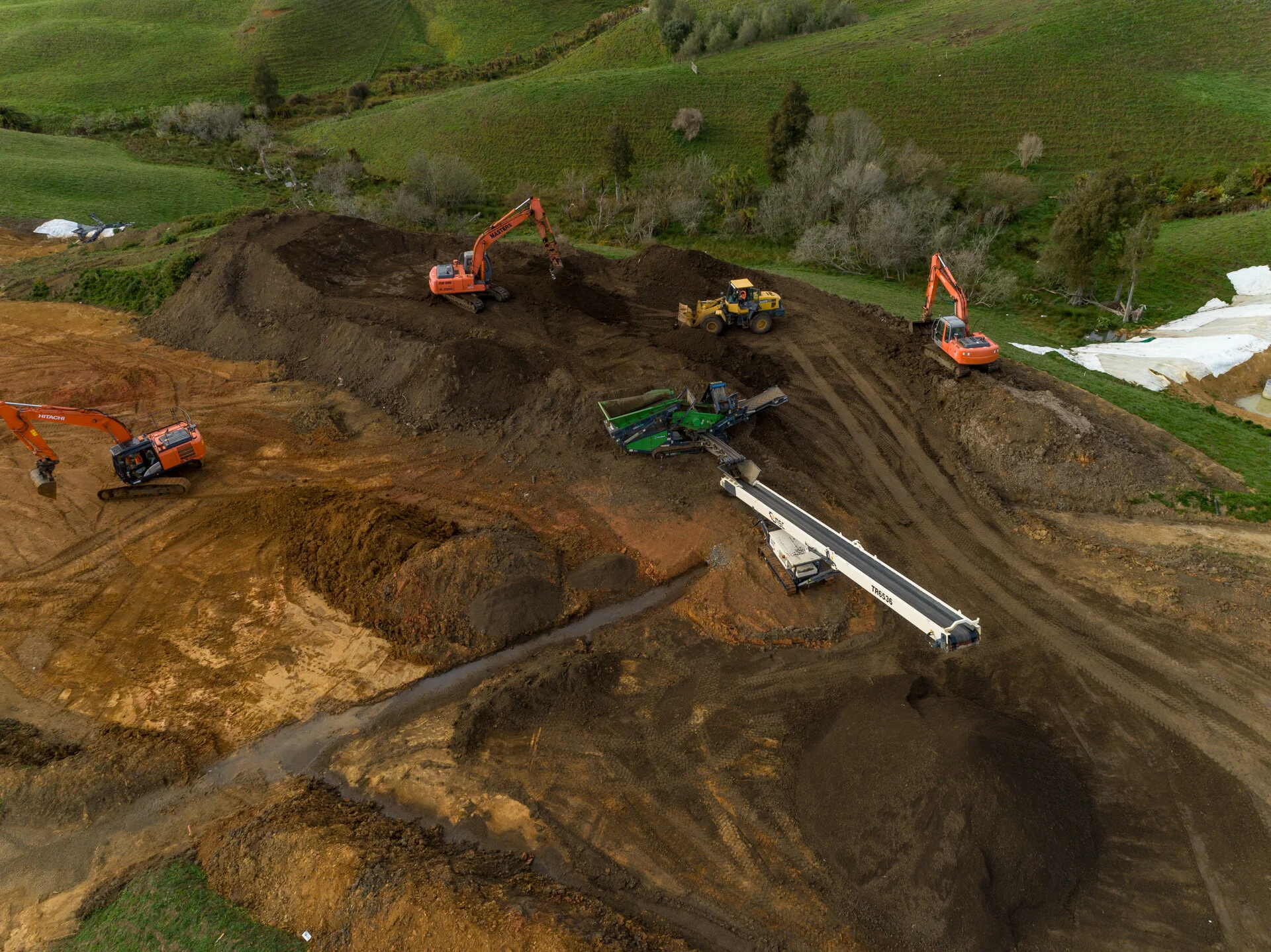 Earth moving equipment at work. Making them look like toys from the drone.