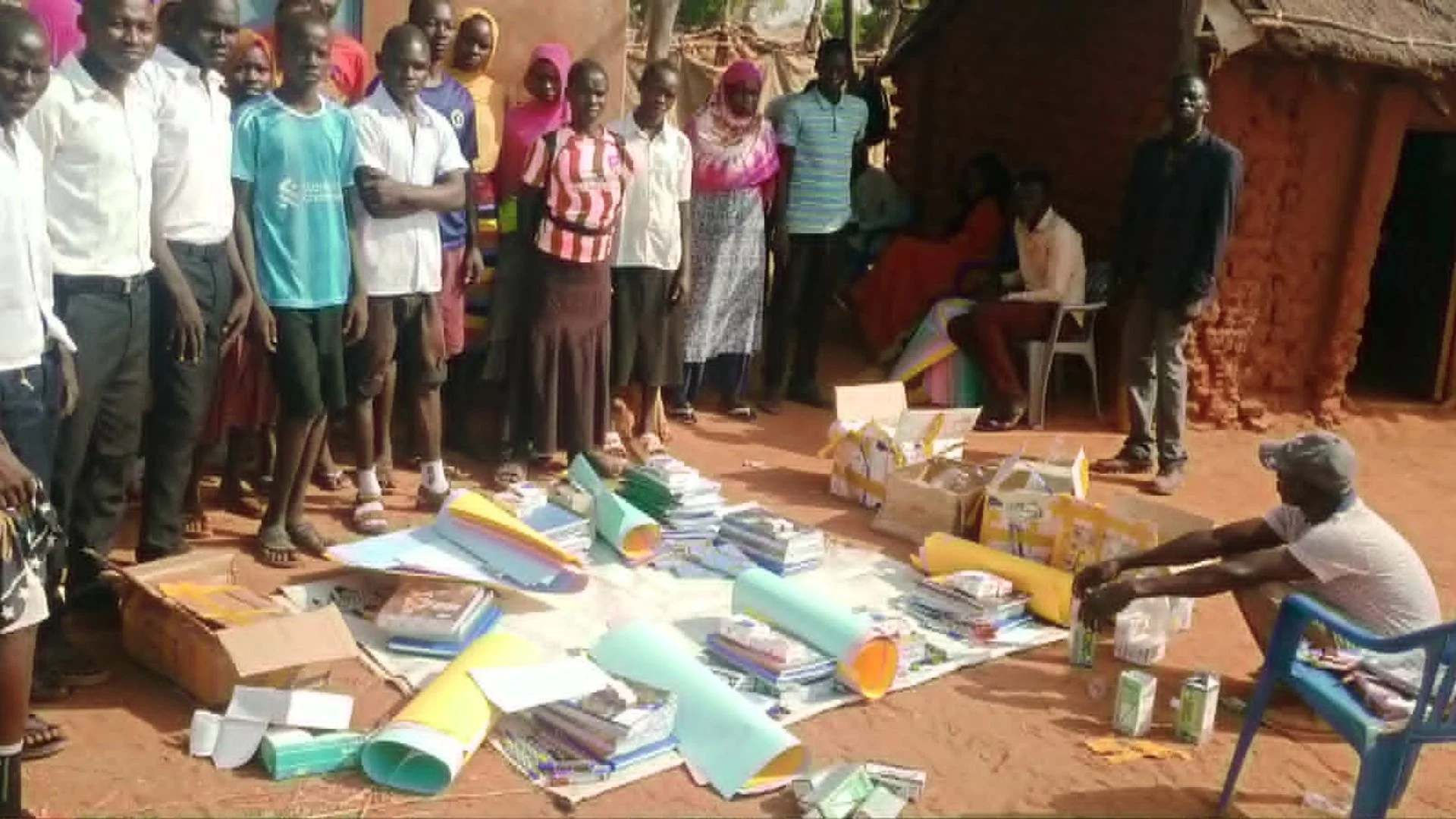 Students and teachers receiving school supplies
