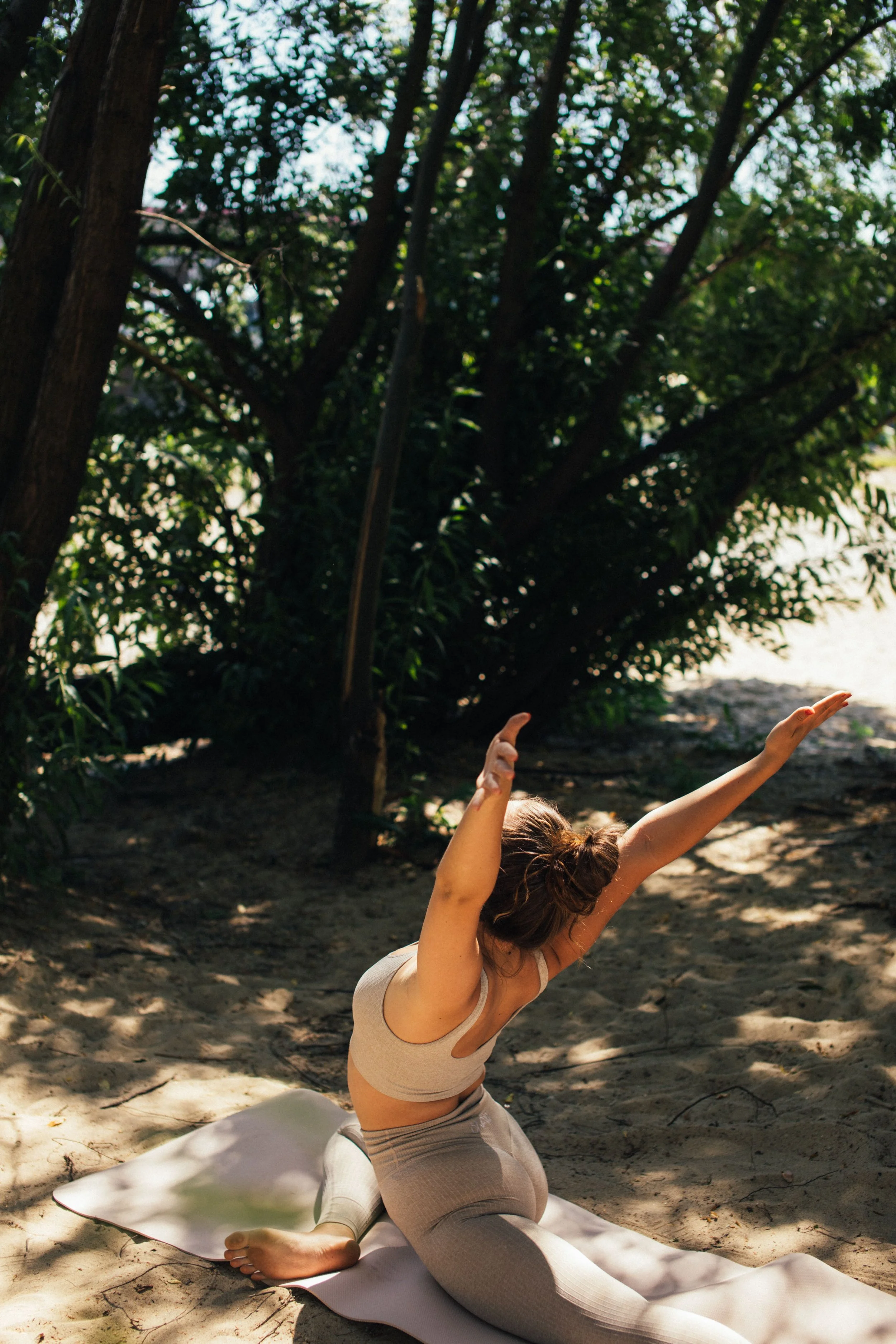 A vibrant midlife woman practicing yoga outdoors, representing joyful movement in holistic menopause management.