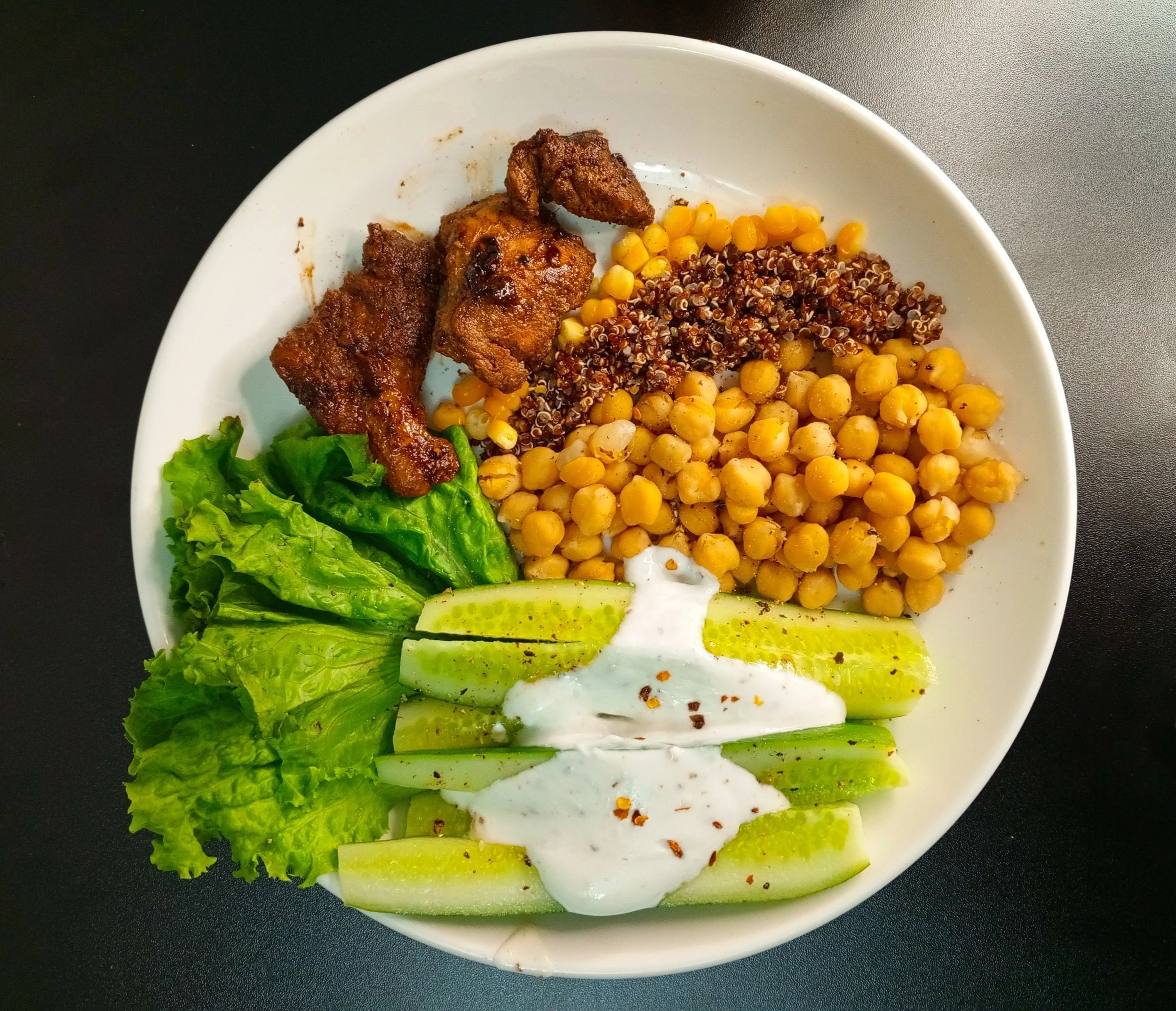 A balanced, protein-rich meal with grilled chicken, vegetables, and a side of healthy fats on a plate.
