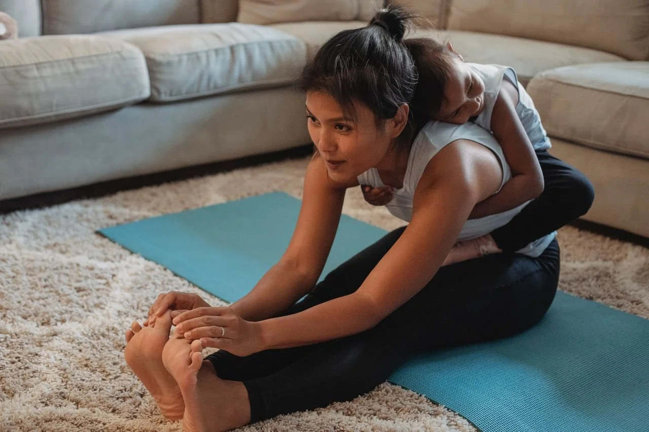 A busy mother dedicating 20 minutes to a home yoga routine to build consistent physical resilience.