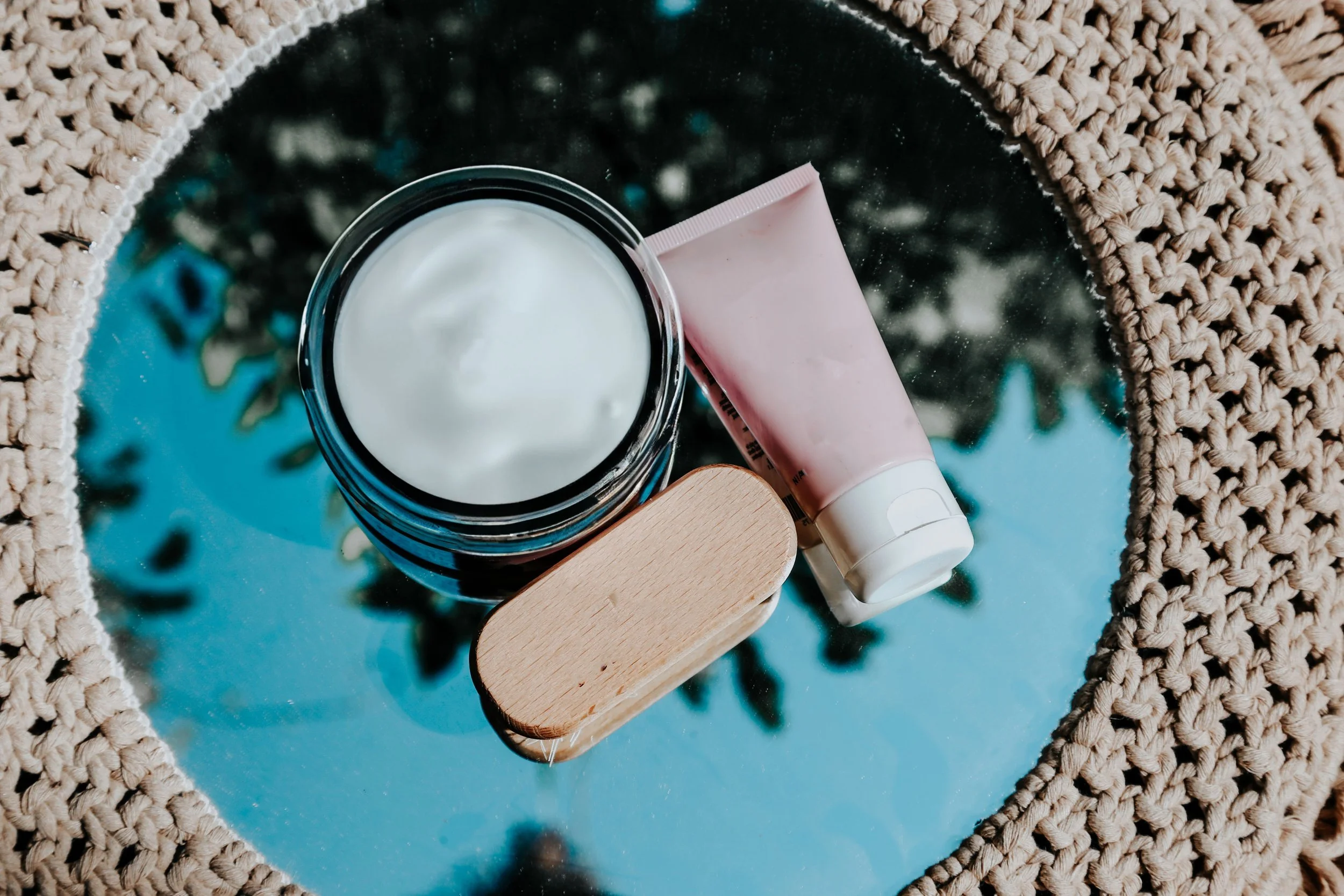 A jar of custom compounded hormone cream resting on a clean, bright medical counter.